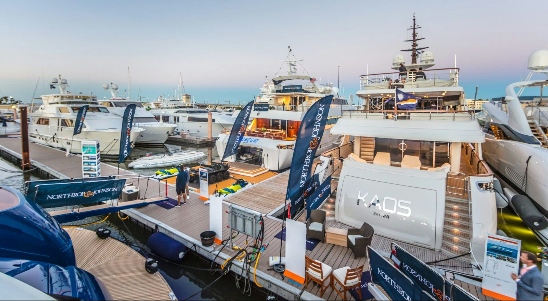 An aerial view capturing the sophistication of a Northrop & Johnson yacht showcased on the dock during the Palm Beach International Boat Show.