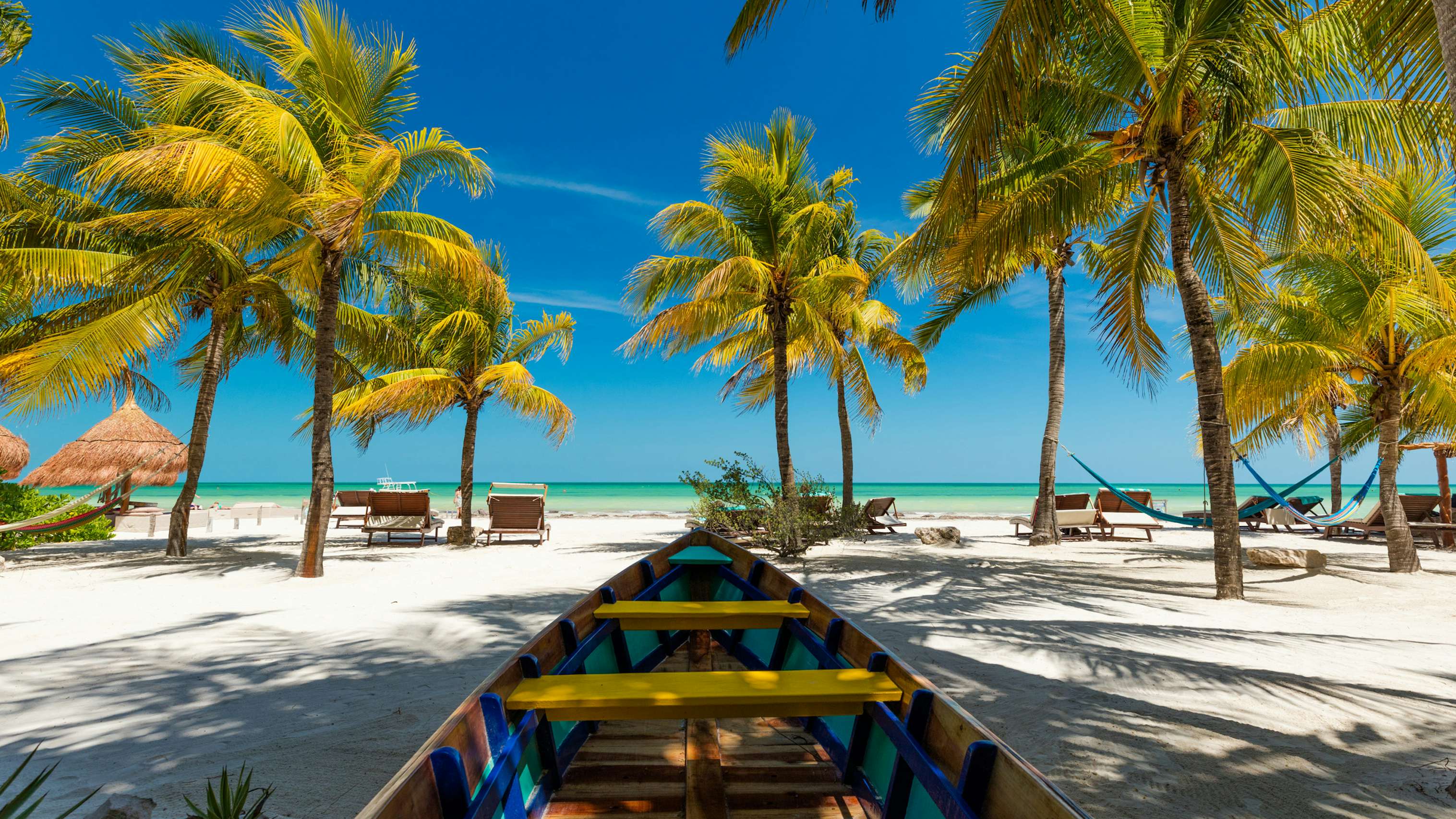 Mexico Holbox Yacht Charter - Tropical beach setting on Isla Holbox, Quintana Roo, Mexico with shady palm trees