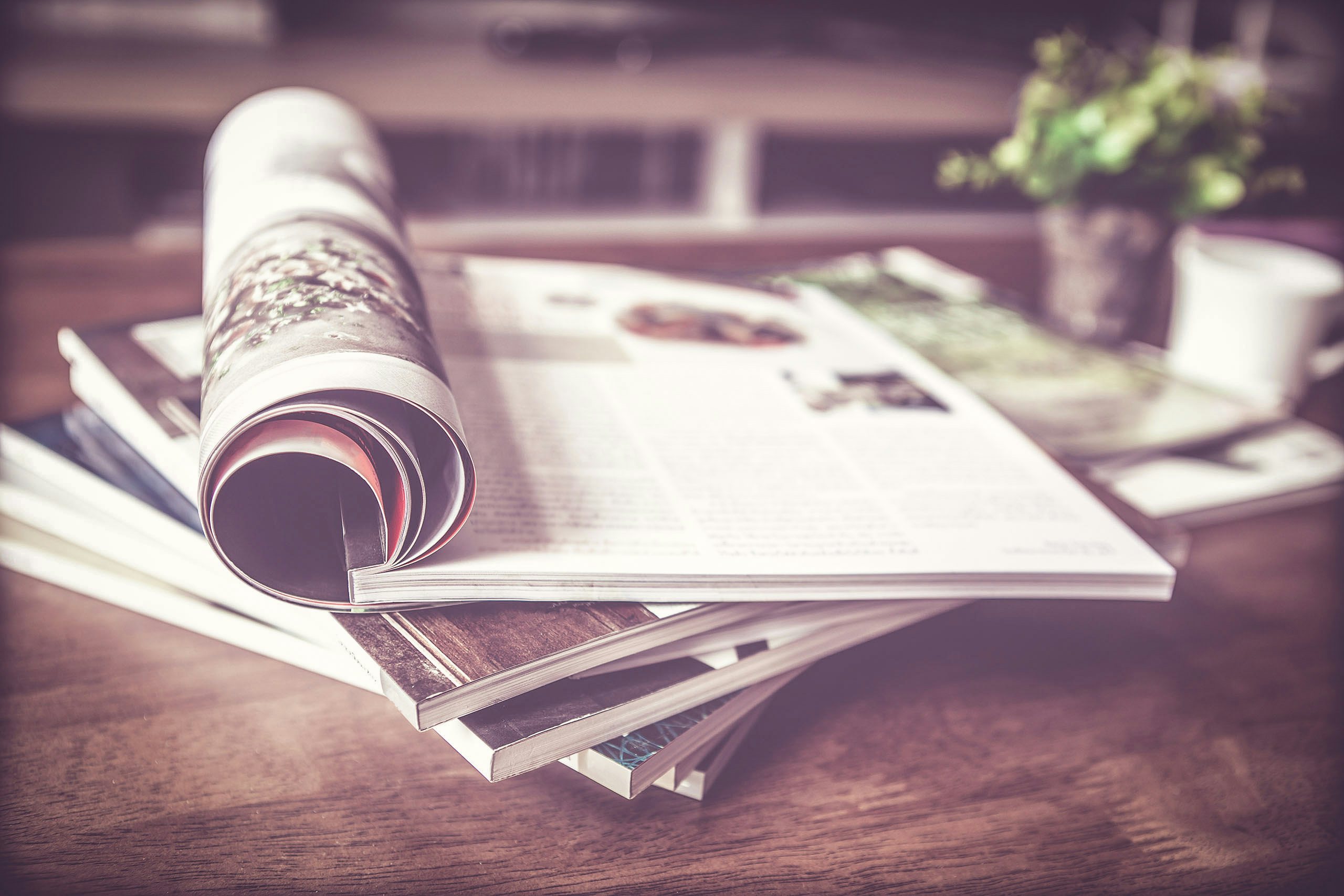 Editorial Focus Stacked magazines on top of table