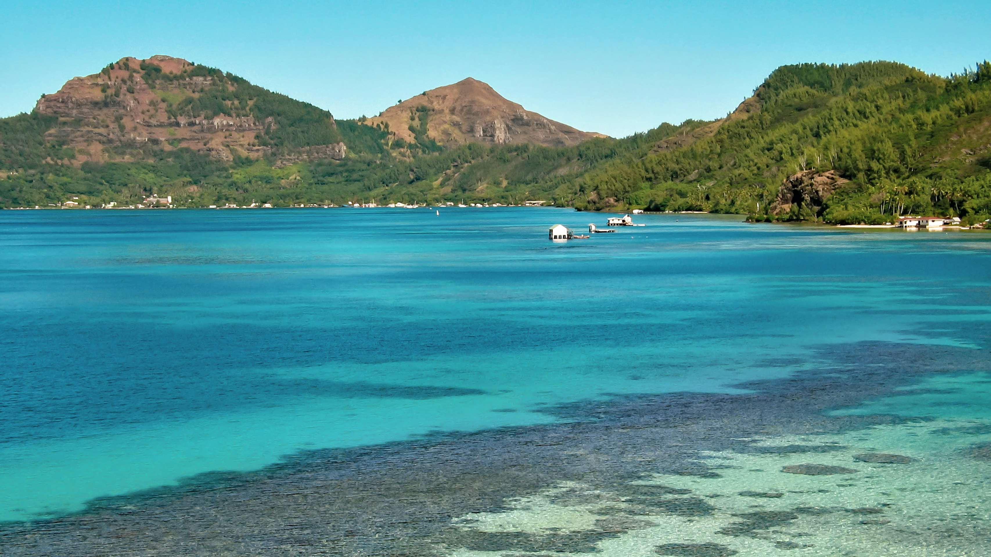 Gambier Islands Yacht Charter - Pearl farms in Polynesia, Gambier Islands Mangareva, blue lagoon and green hills.