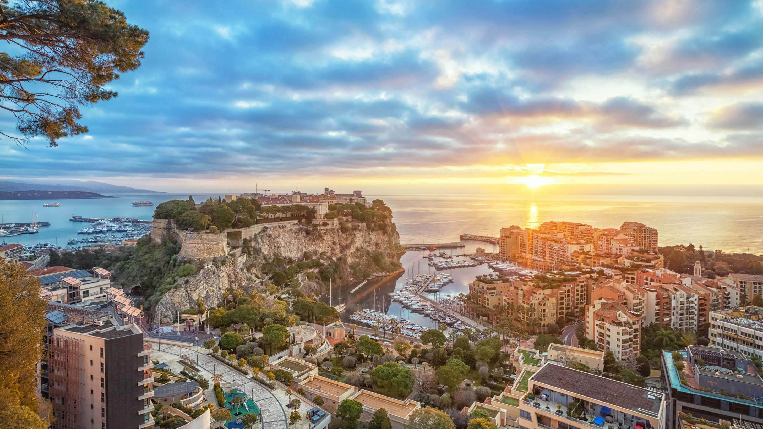 Sunset view over the lavish cityscape of Monaco, a premier destination for luxury yacht charters on the French Riviera