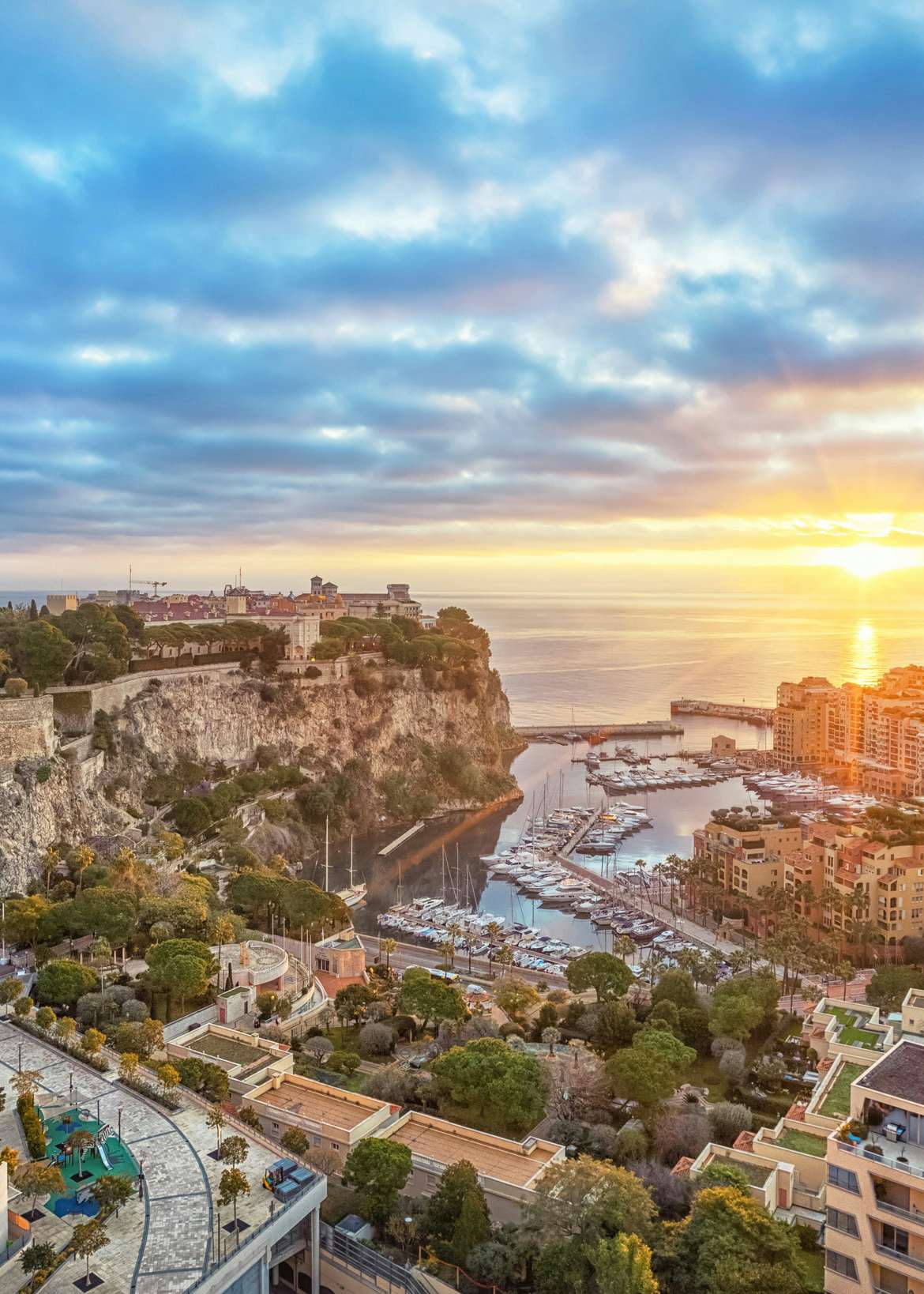 Sunset view over the lavish cityscape of Monaco, a premier destination for luxury yacht charters on the French Riviera