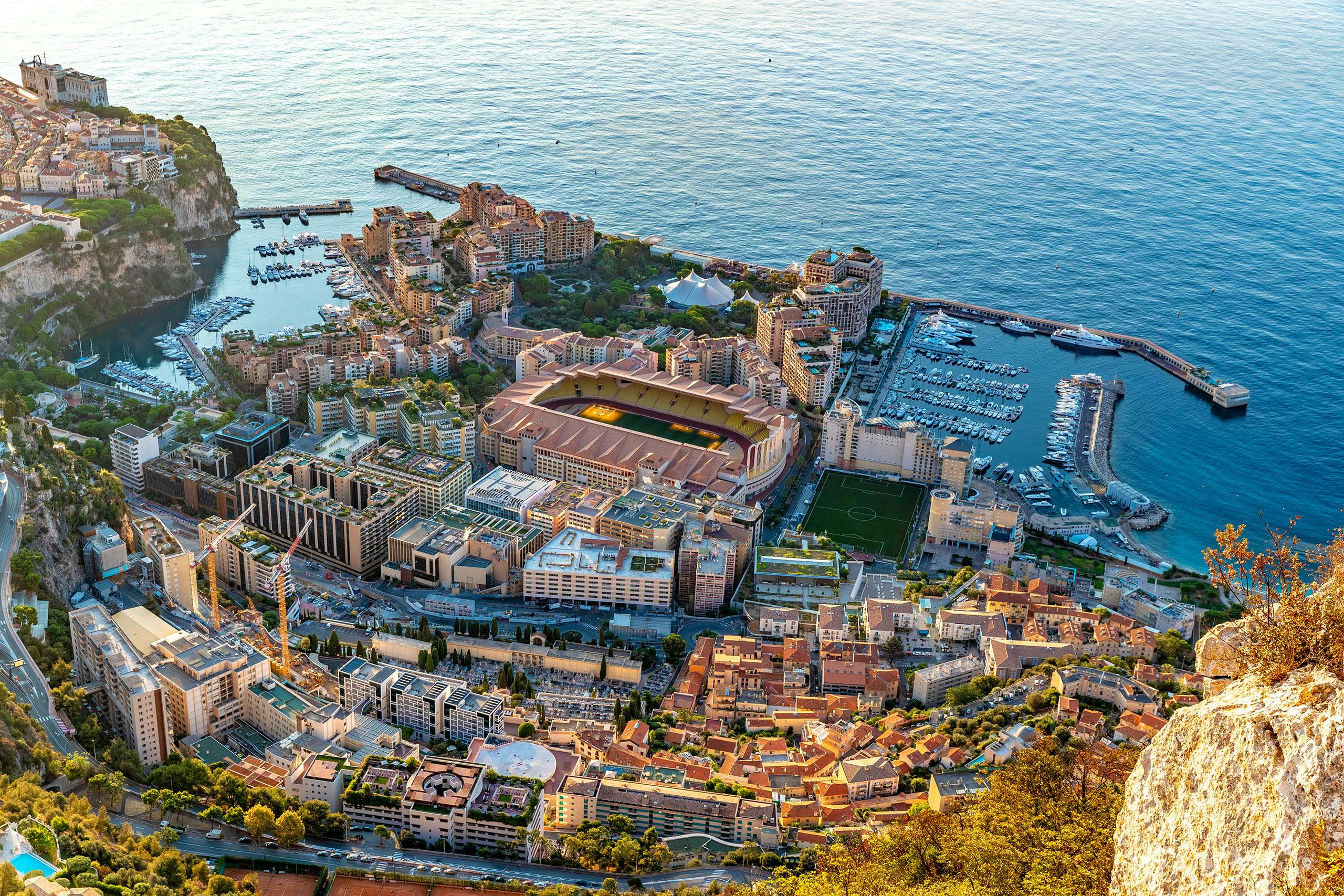 Panoramic view of Monte Carlo harbor filled with luxury yachts, encapsulating the essence of yacht charter in Monaco