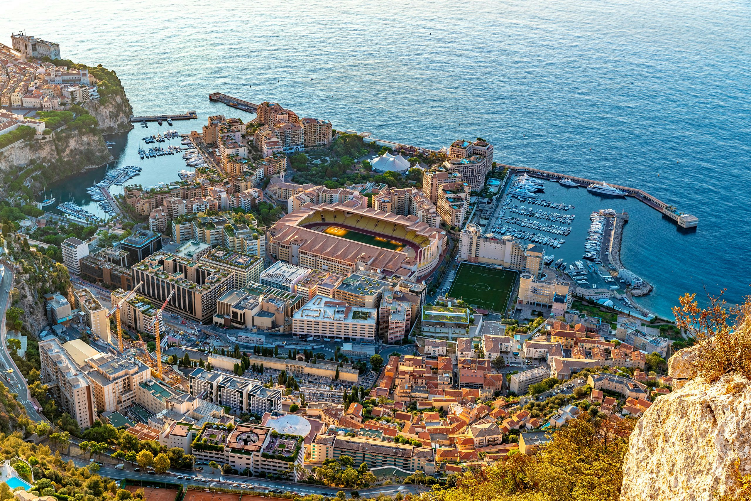 Monte Carlo Harbor - The Heart of Yacht Charter Luxury in Monaco Panoramic view of Monte Carlo harbor filled with luxury yachts, encapsulating the essence of yacht charter in Monaco
