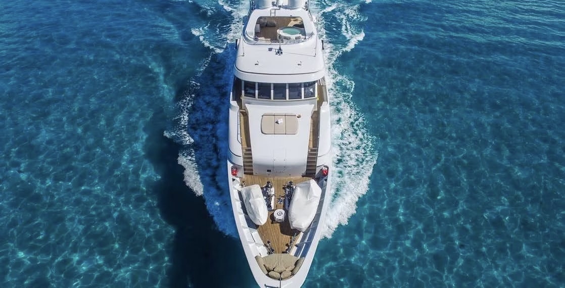 superyacht go cruising in blue water head on with a view of her bow