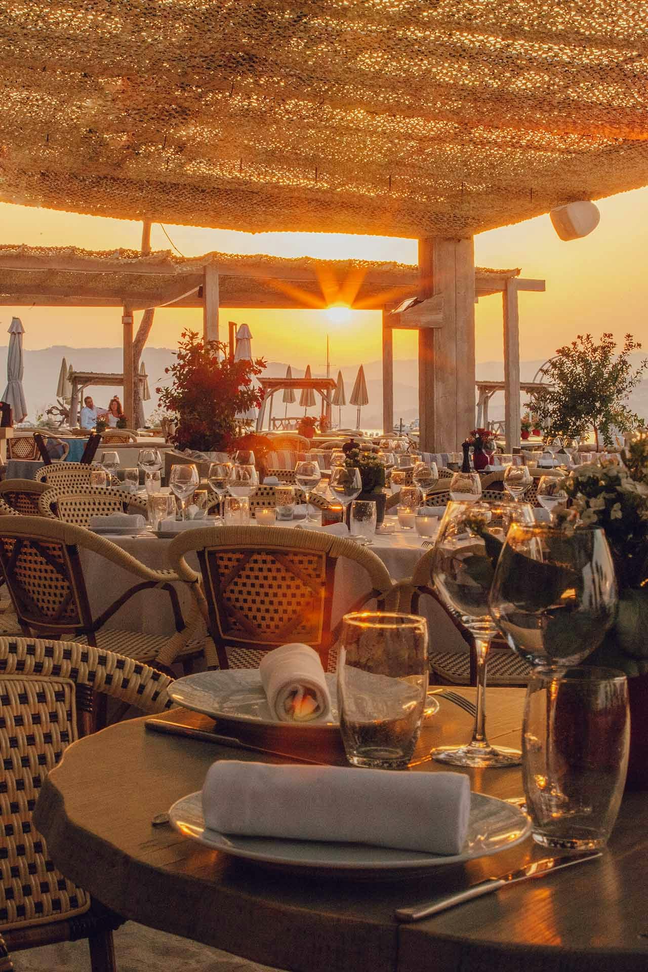 View of the sunset over tables set up at a restaurant