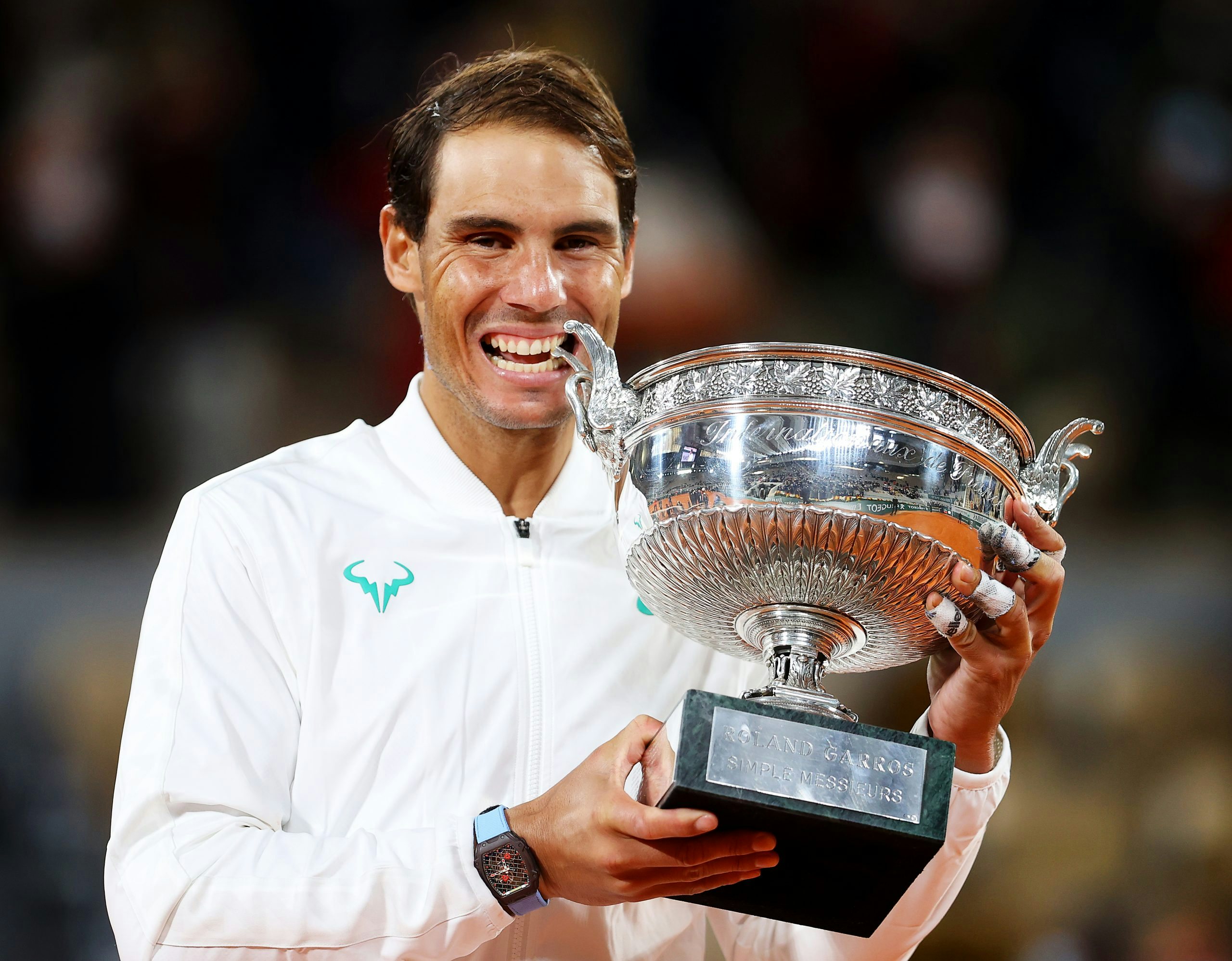 PARIS, FRANCE - OCTOBER 11: Rafael Nadal of Spain bites the winners trophy following victory in his Men's Singles Final against Novak Djokovic of Serbia on day fifteen of the 2020 French Open at Roland Garros on October 11, 2020 in Paris, France. (Photo by Julian Finney/Getty Images)