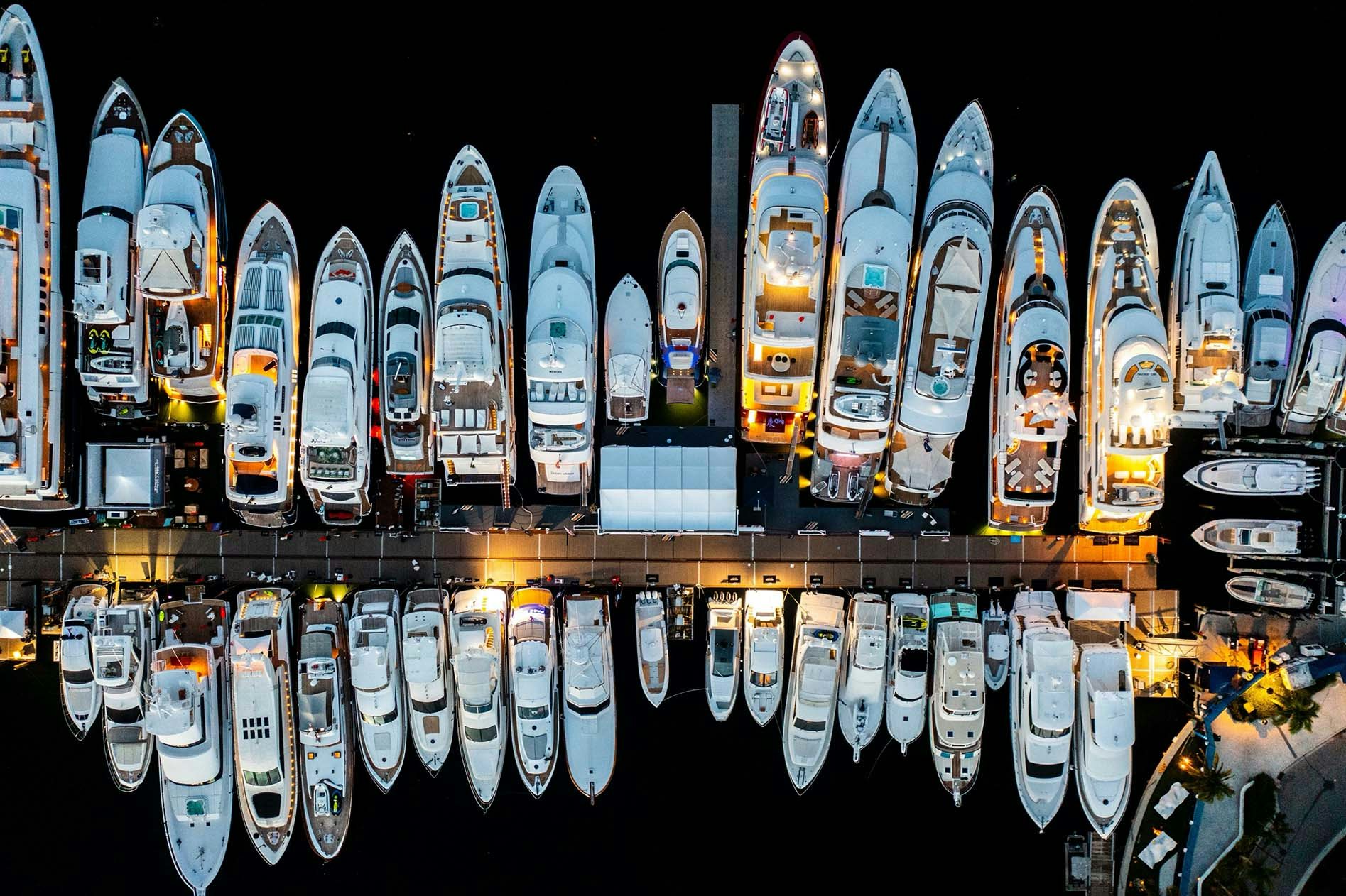 Nighttime shot of the yachts on display above