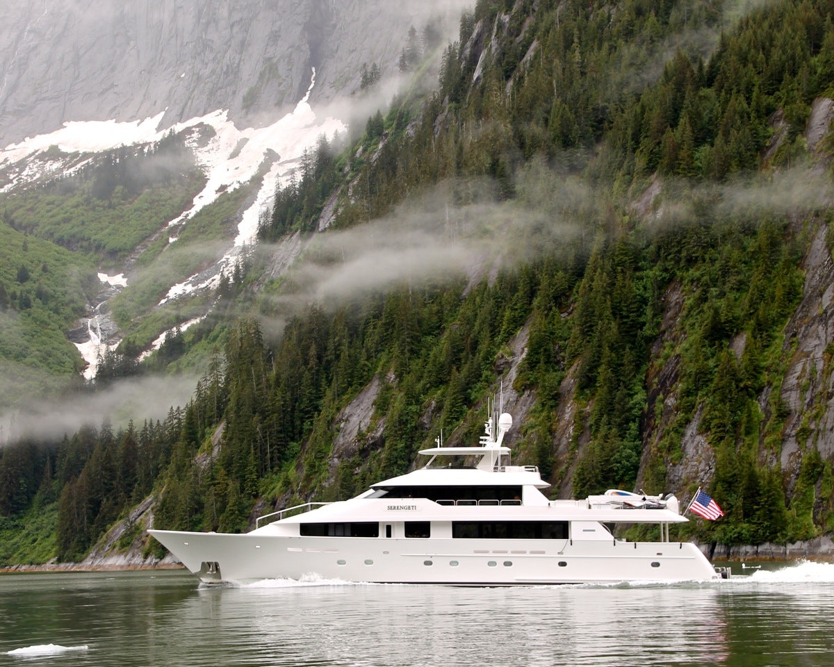 serengeti yacht in serene water in front of a large mountain in alska