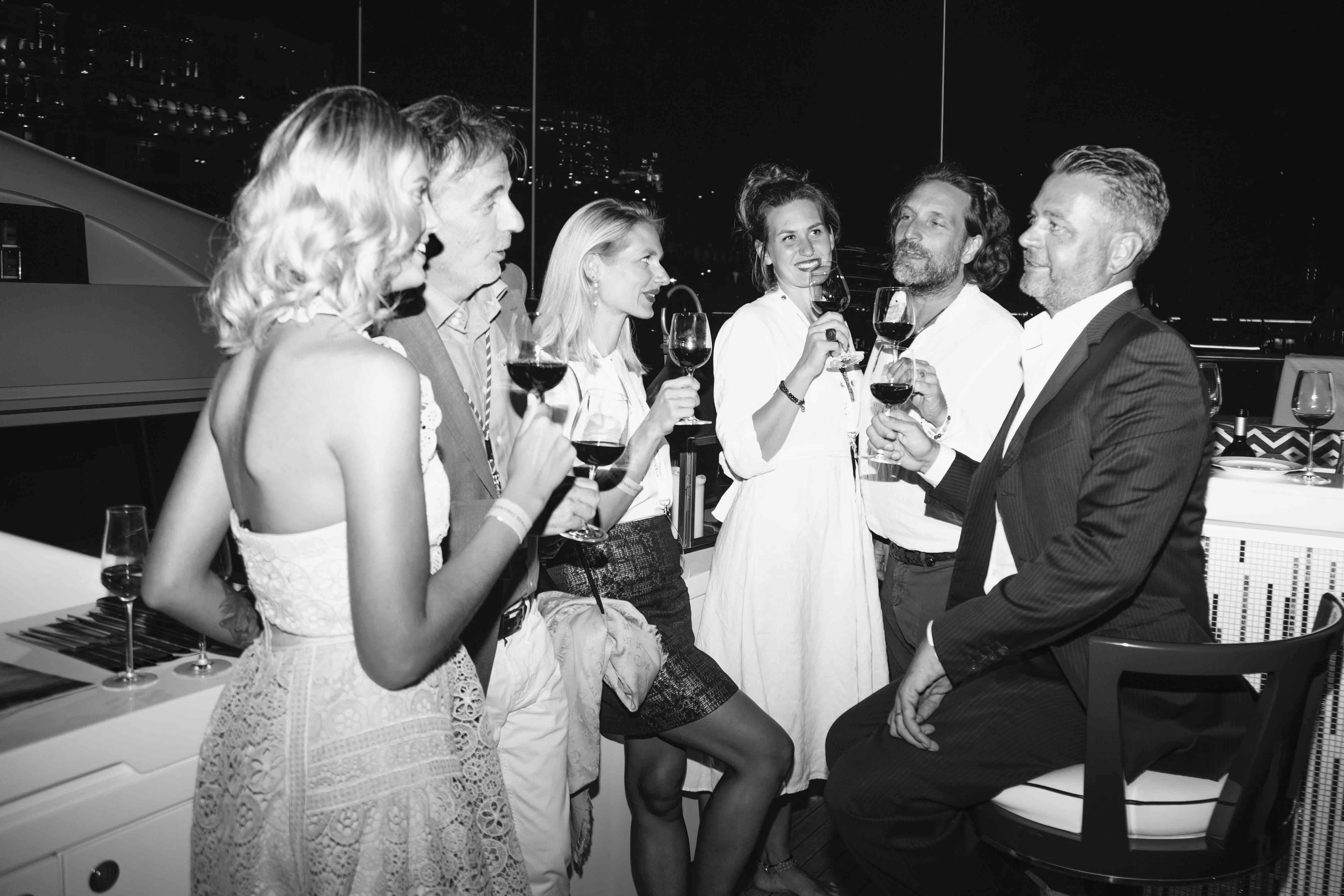 People sipping wine on yacht in the evening