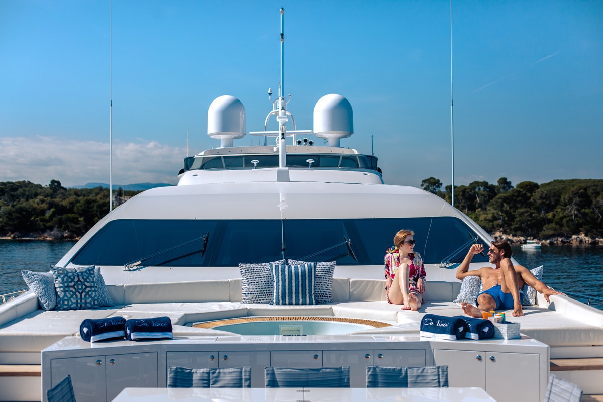 Two girls lounging on the foredeck of DA VINCI