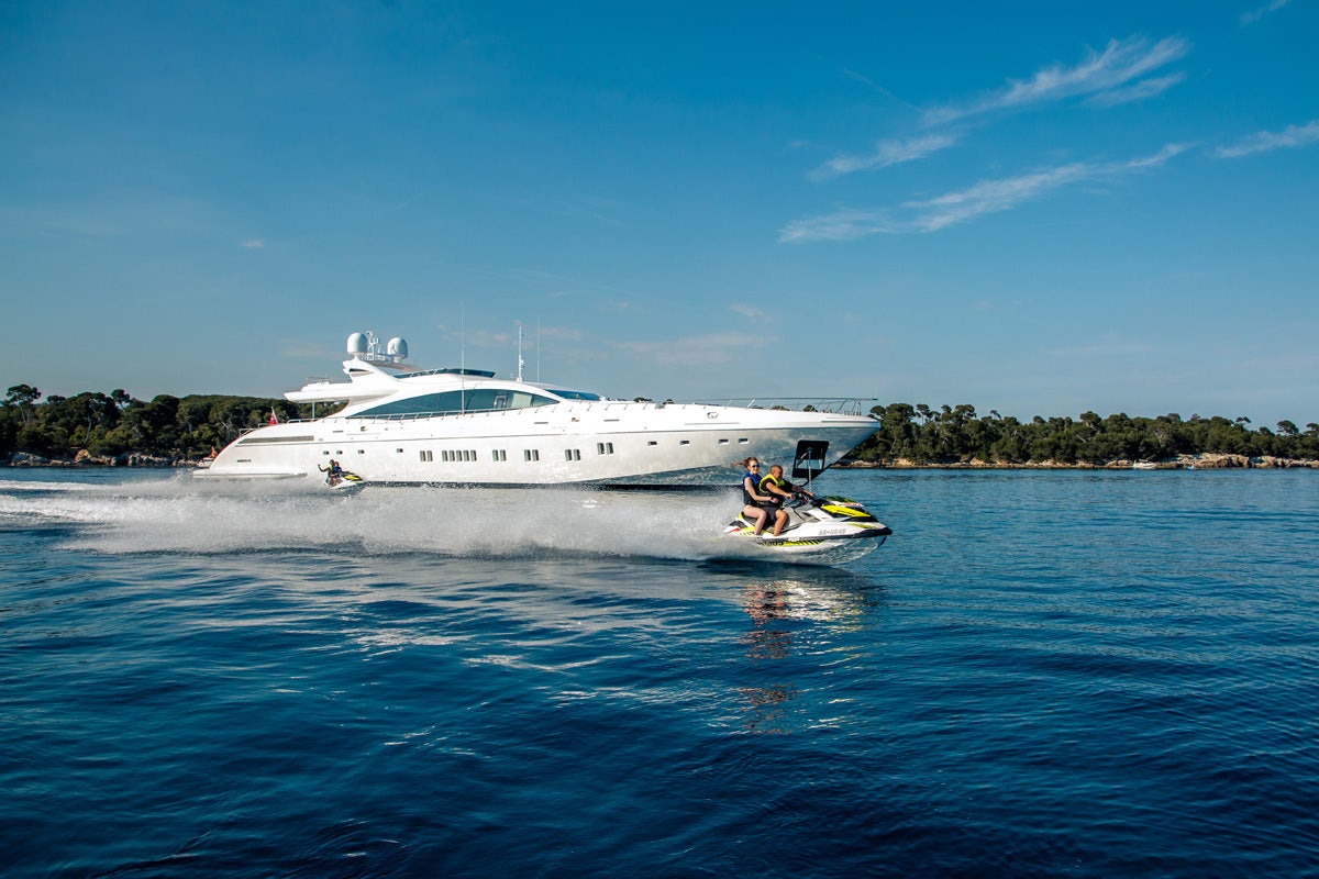 DaVinci mangusta mediterranean yacht charter at anchor with Wave Runners cruising by
