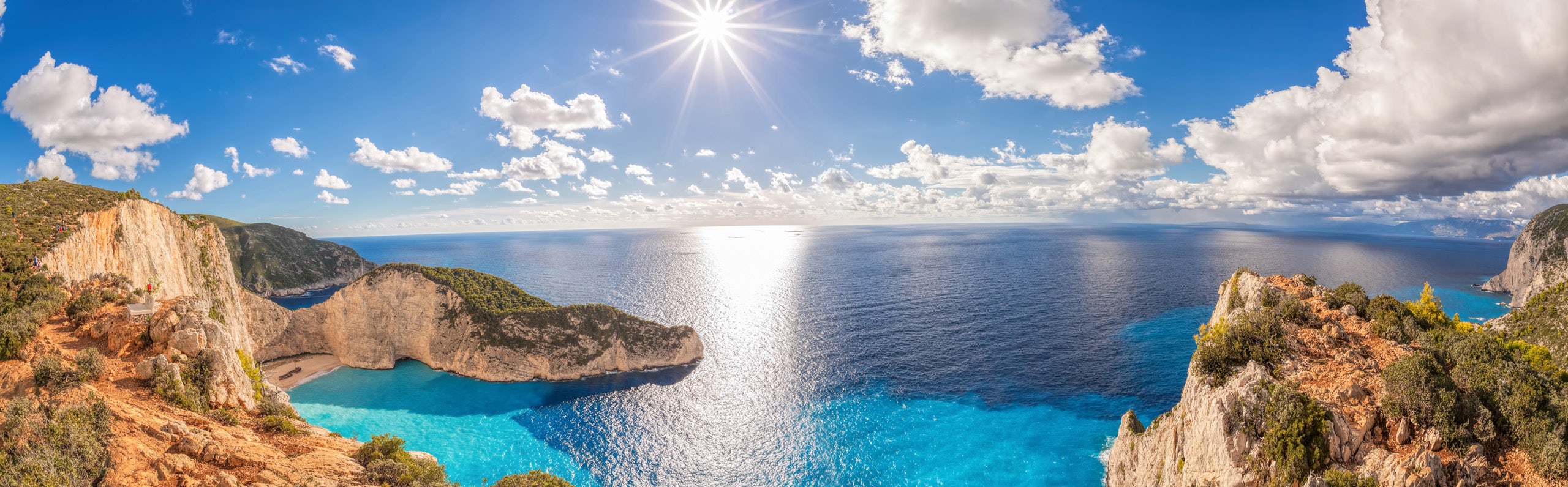 Breathtaking cliffs of the Ionian Islands shine under the Mediterranean sun, inviting exploration by yacht.