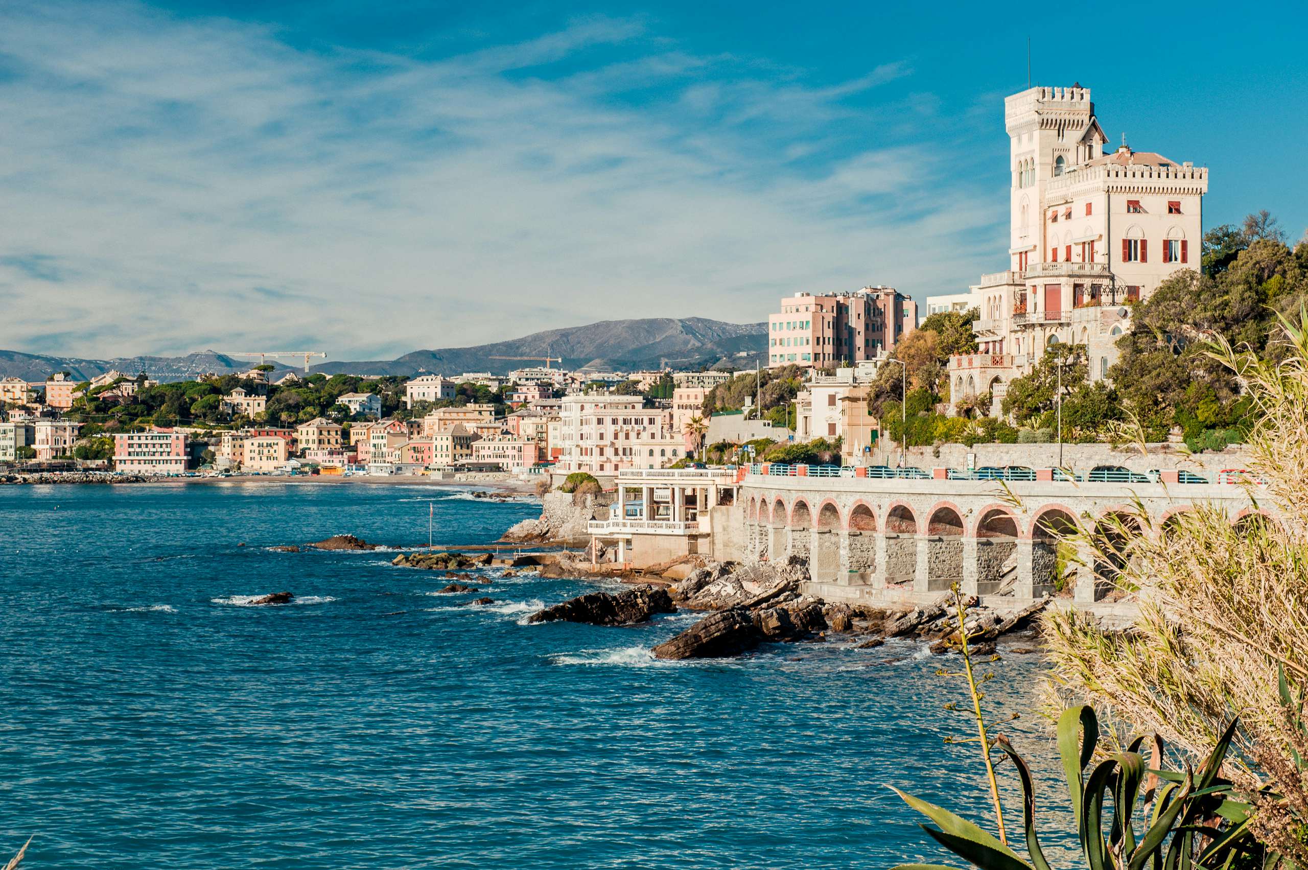 The historic waterfront of Genoa, with its renowned architecture, as seen from the Italian Riviera yacht route.