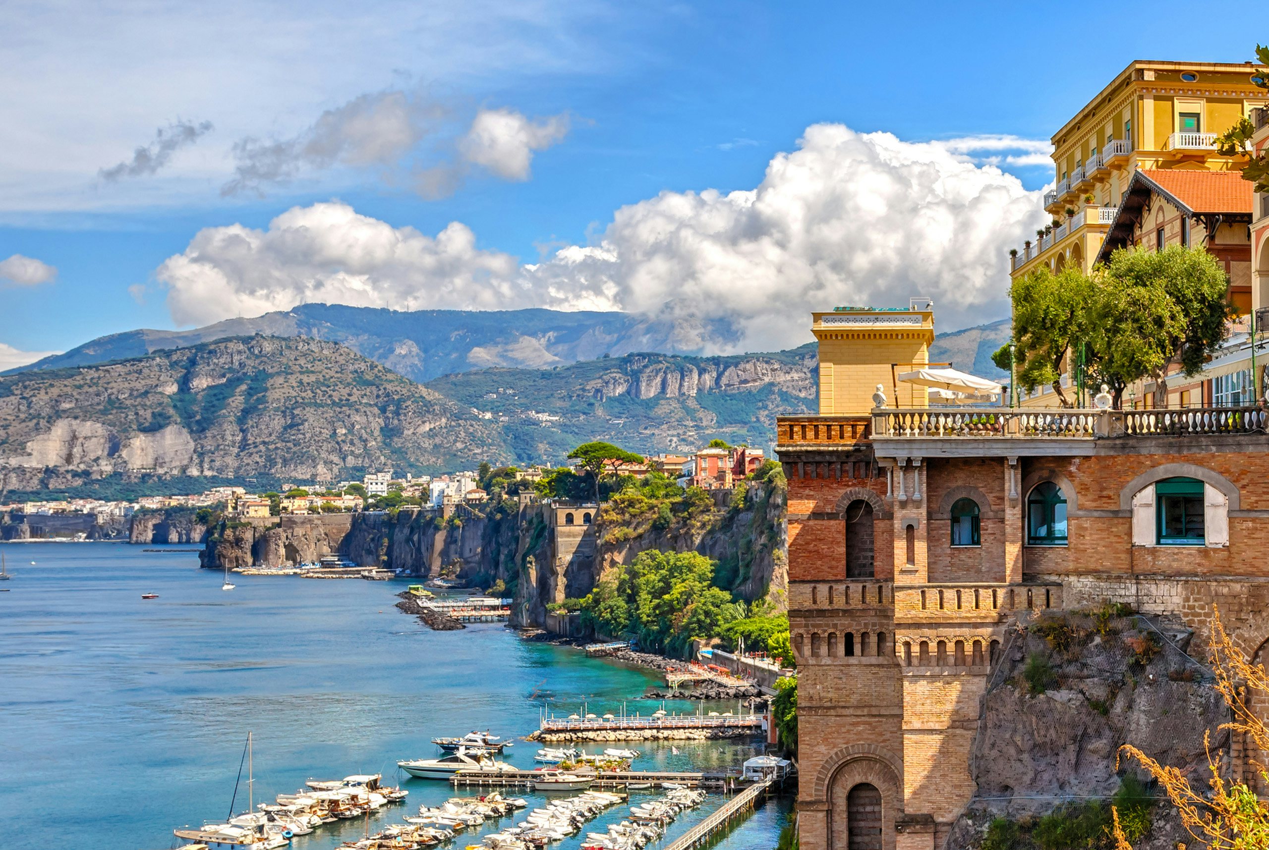 Sorrento's Grandeur | Luxurious Yacht Charters | Northrop & Johnson Overlooking view of Sorrento's historic architecture with the serene blue sea in the background.