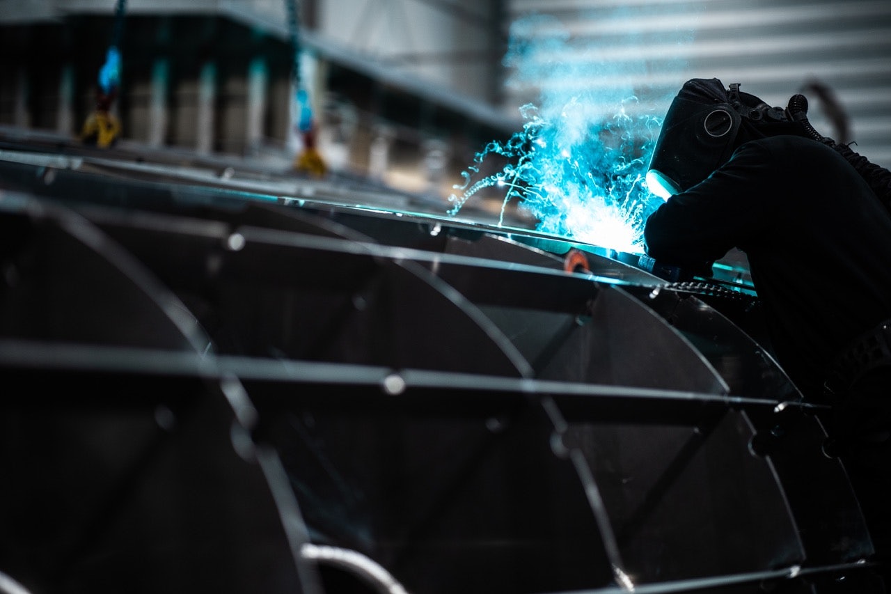 photo of a Van der Valk construction welder in action with equipment and protective gear close up shot