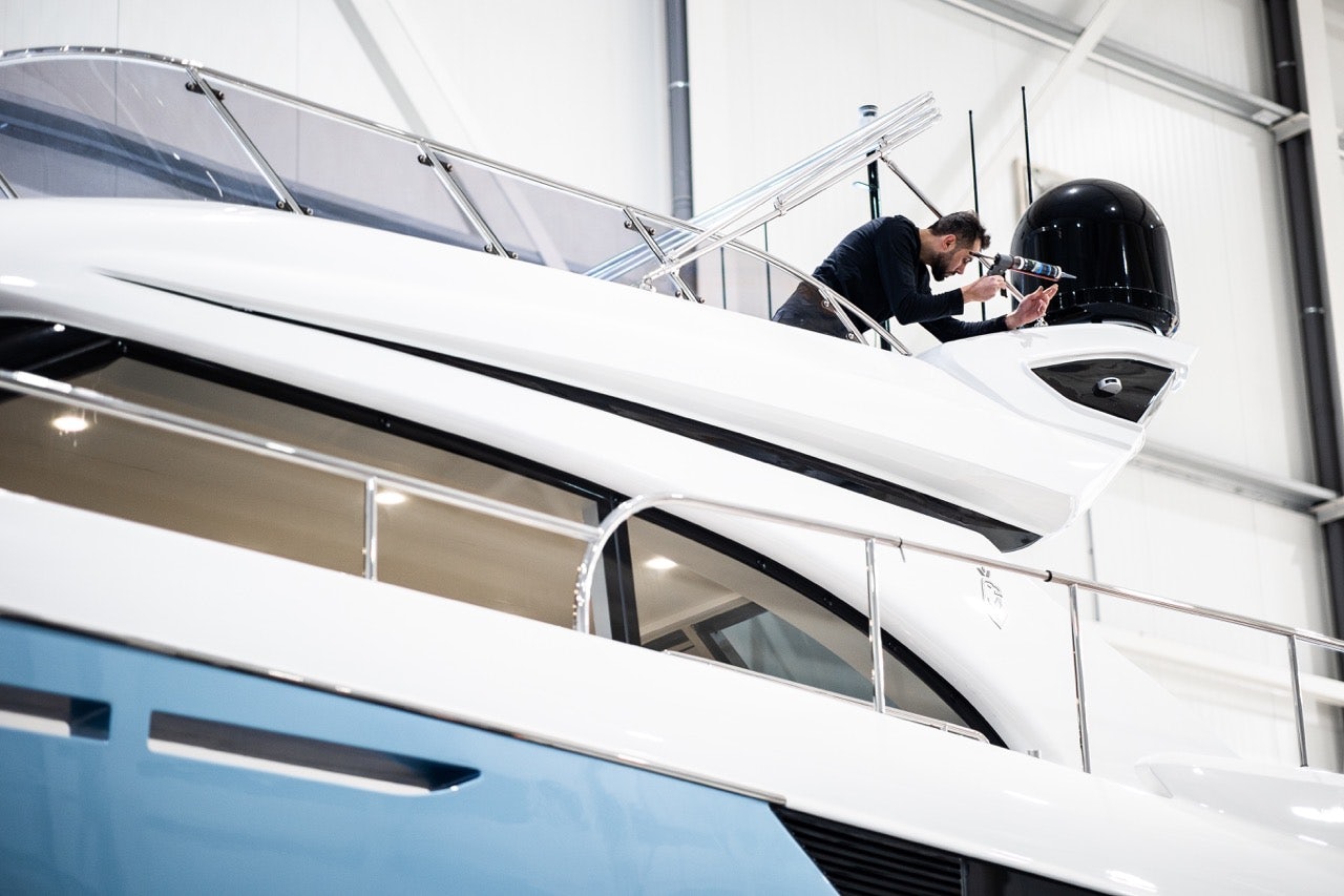 a man putting finishing touches on a new yacht construction at Van der Valk shipyard