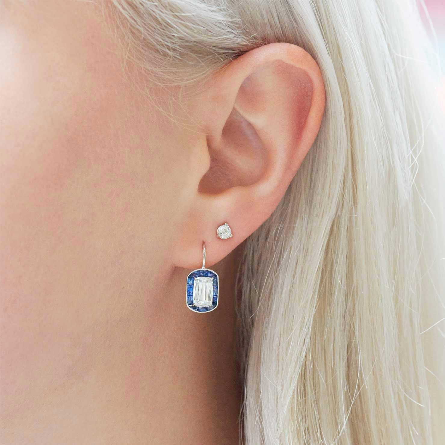 diamond earrings on French hooks with sapphire halo.