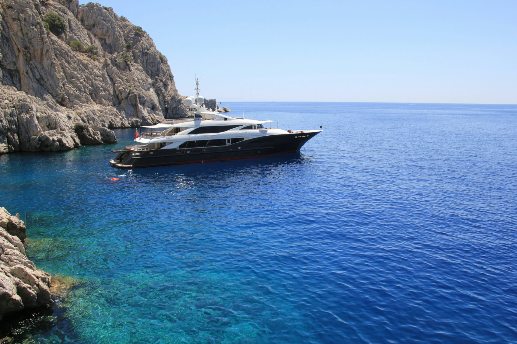 Liberty yacht for charter at anchor in mediterranean sea off coast