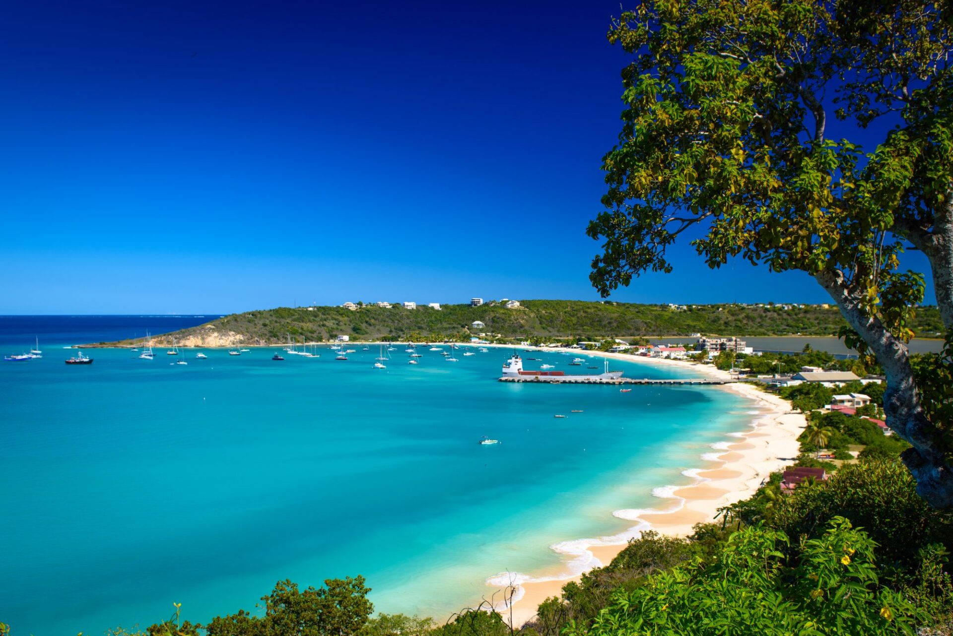 A captivating aerial view of Anguilla's Leeward Islands, a prime yacht charter destination featuring white sand beaches, azure waters, and lush green landscapes.