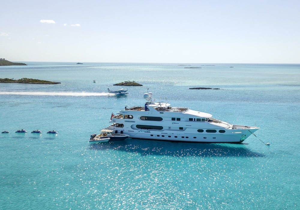 MILESTONE at anchor with a sea plane and jet skis off the stern