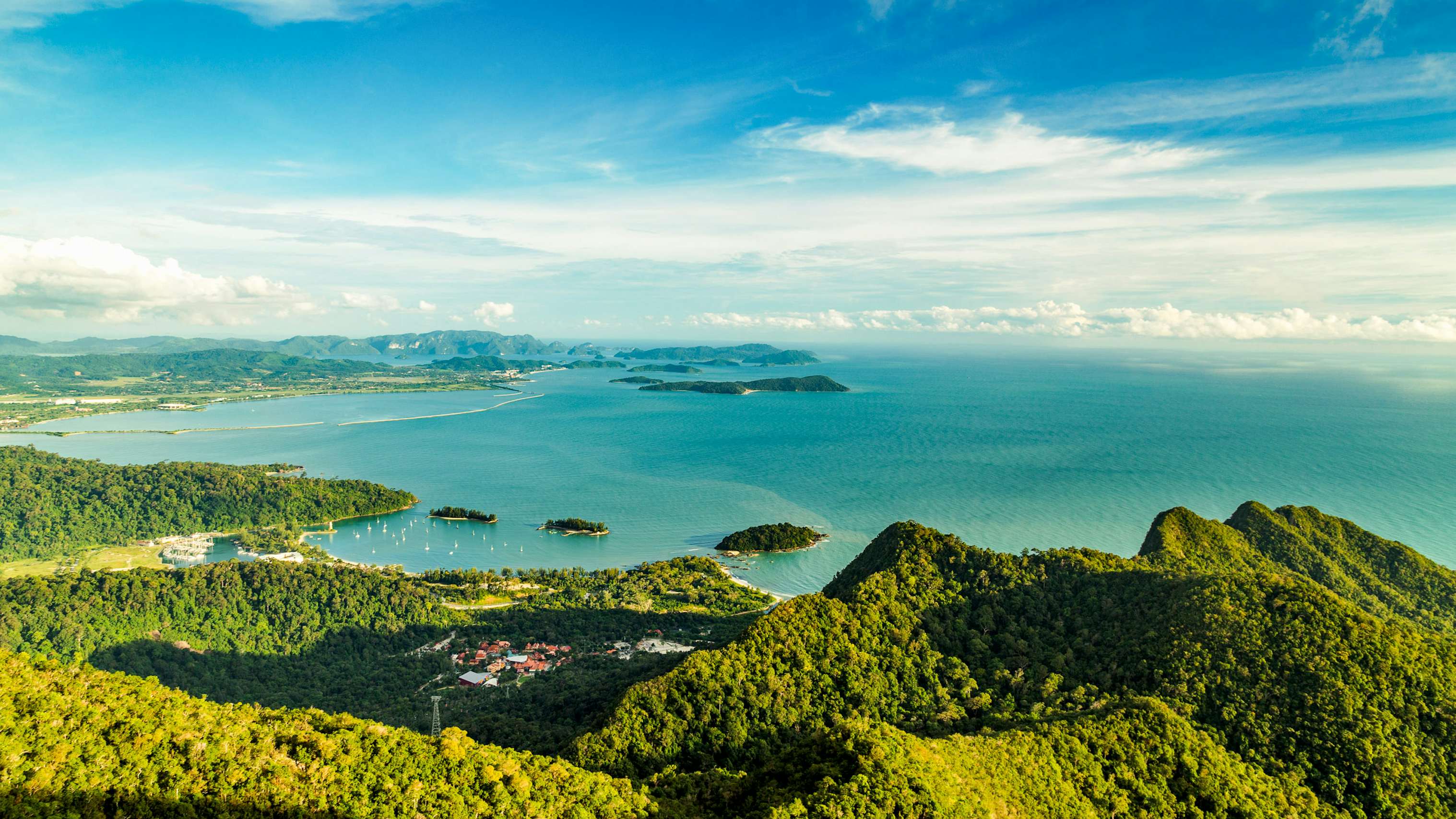 Malaysia Yacht Charter - Langkawi Yacht Charter View of tropical island Langkawi in Malaysia, covered with tropical forests. Aerial view on the bay, marina and archipelago of smaller islands in Andaman sea