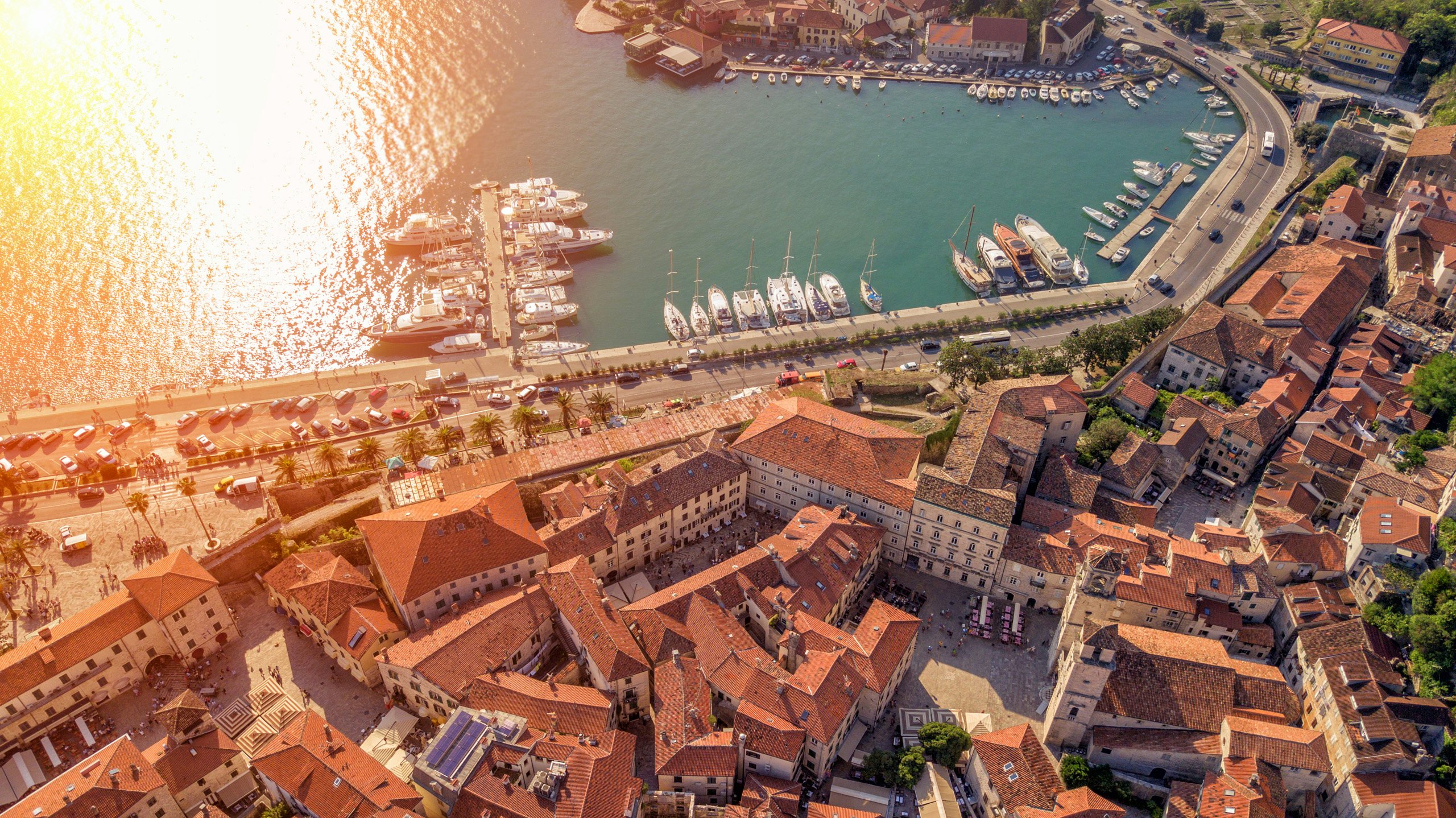 Montenegro Marina - A Gateway to Luxury Yacht Charters with N&J Aerial view of a Montenegrin marina filled with yachts, showcasing the potential for luxury yacht charters with N&J.