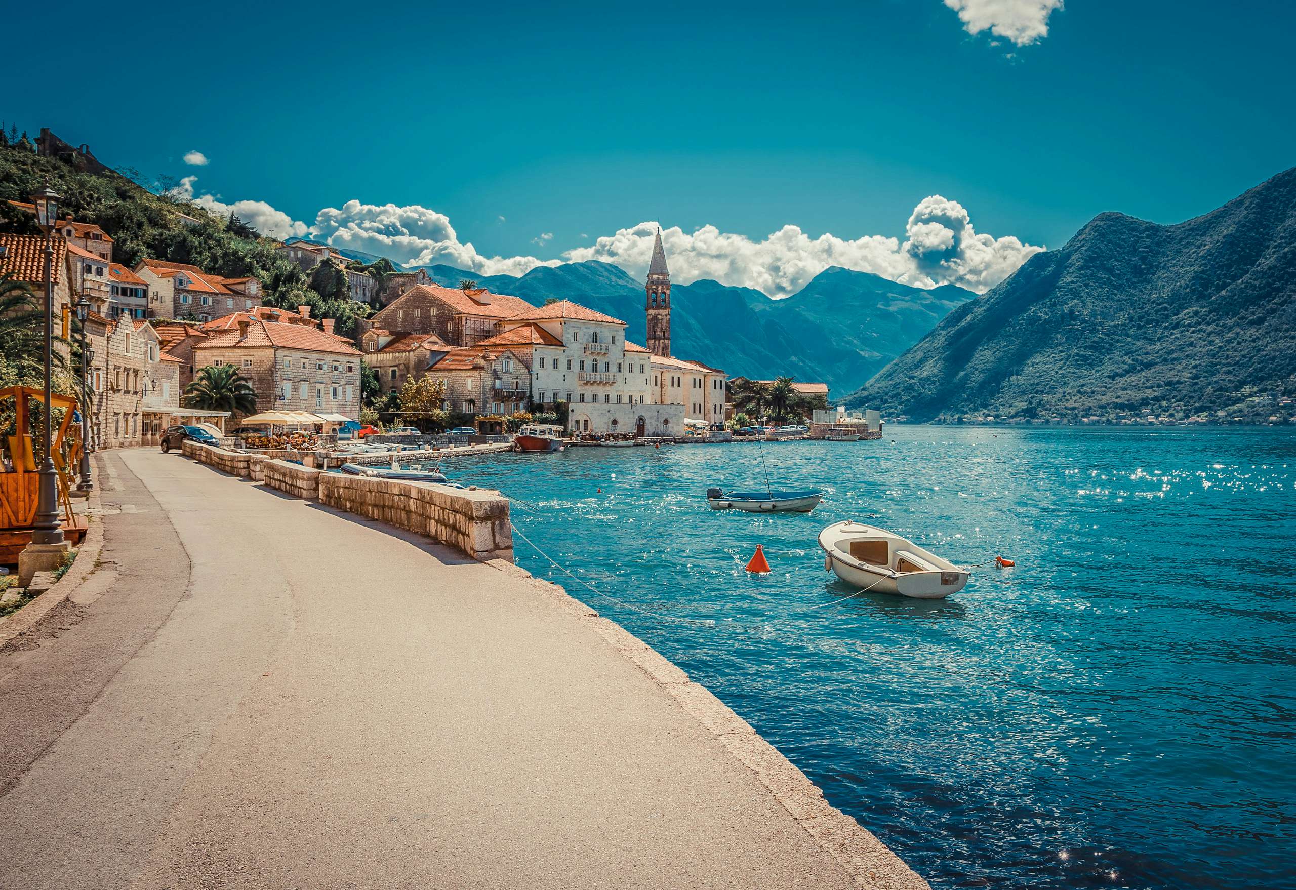 Pristine Montenegrin coastline with yachts and boats, a prime location for N&J yacht charter customers seeking relaxation and exploration.