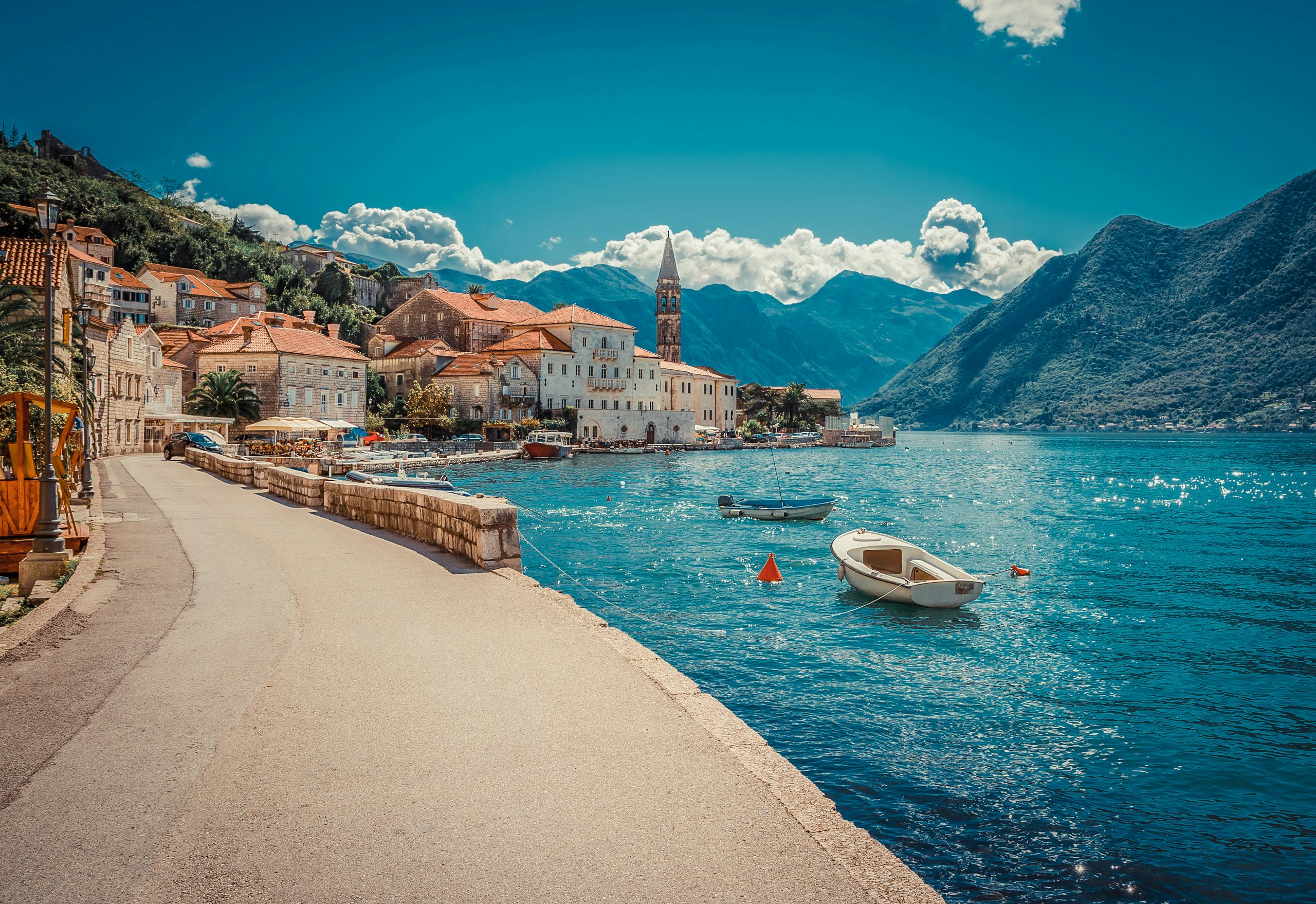 Montenegro’s Coastal Charm - Premier Yacht Charter by N&J Pristine Montenegrin coastline with yachts and boats, a prime location for N&J yacht charter customers seeking relaxation and exploration.