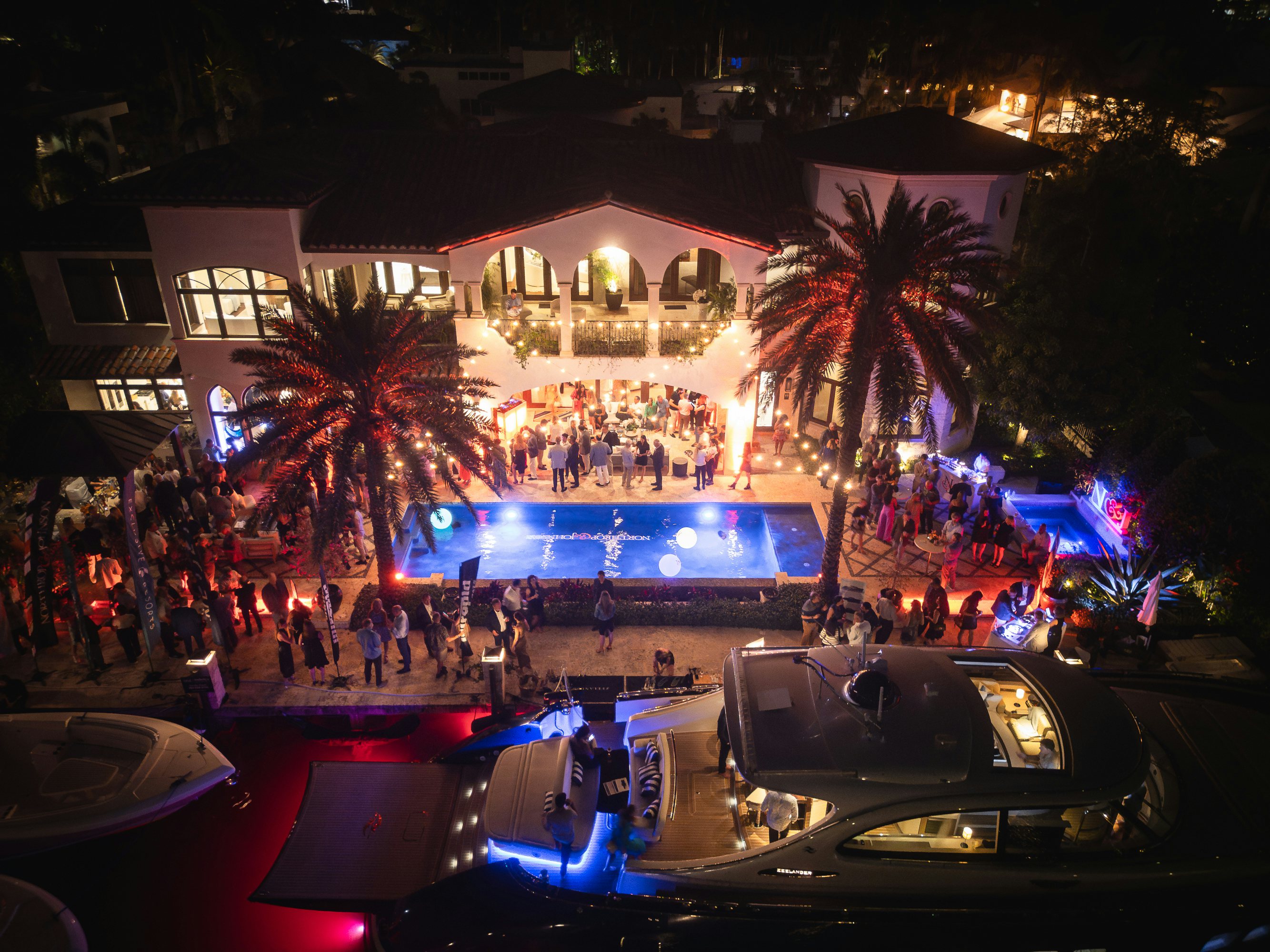 N&J FLIBS 2024 client evening event party with lights and pool