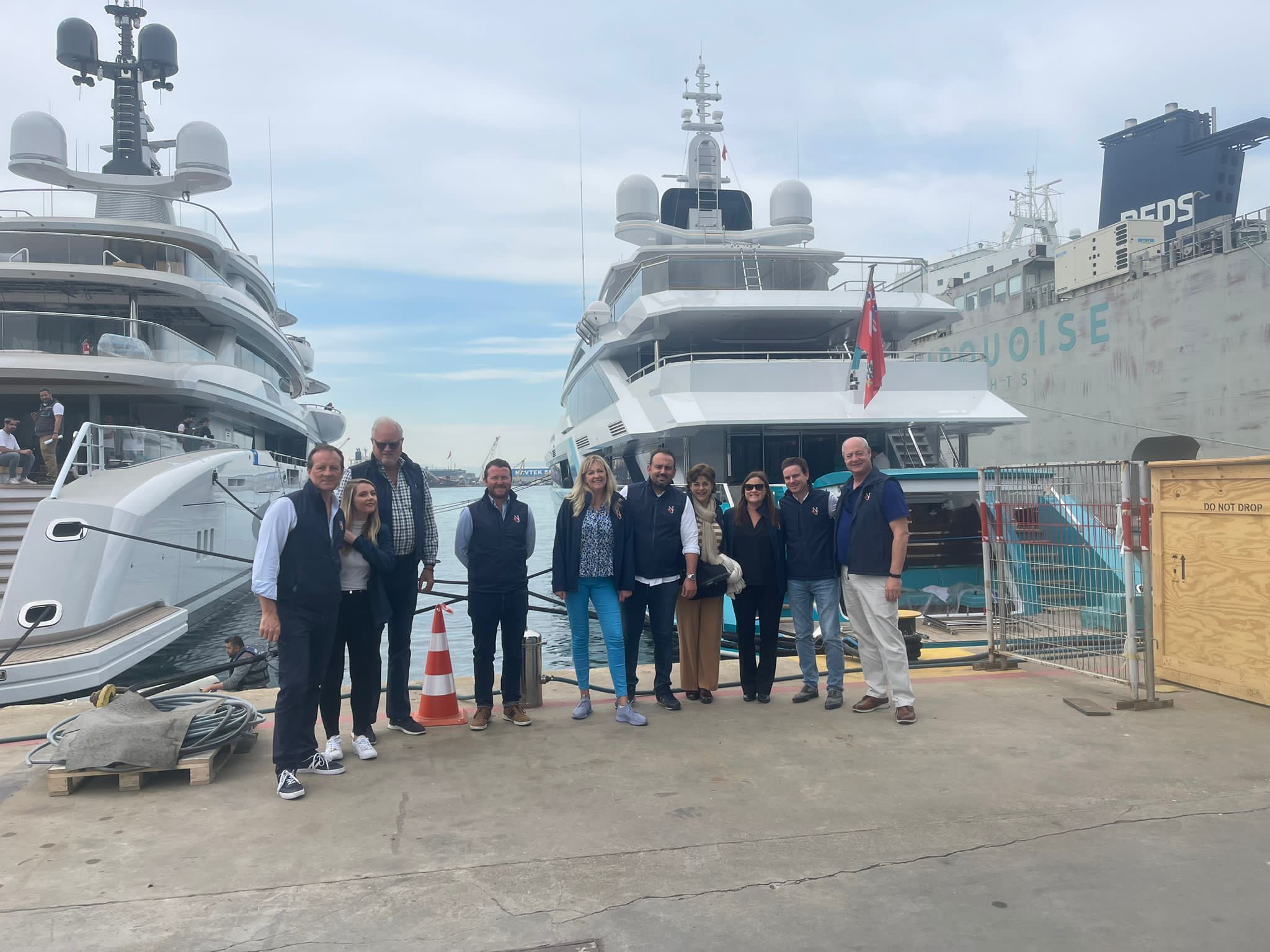 NJ brokers at a shipyard in turkey in front of a ycht