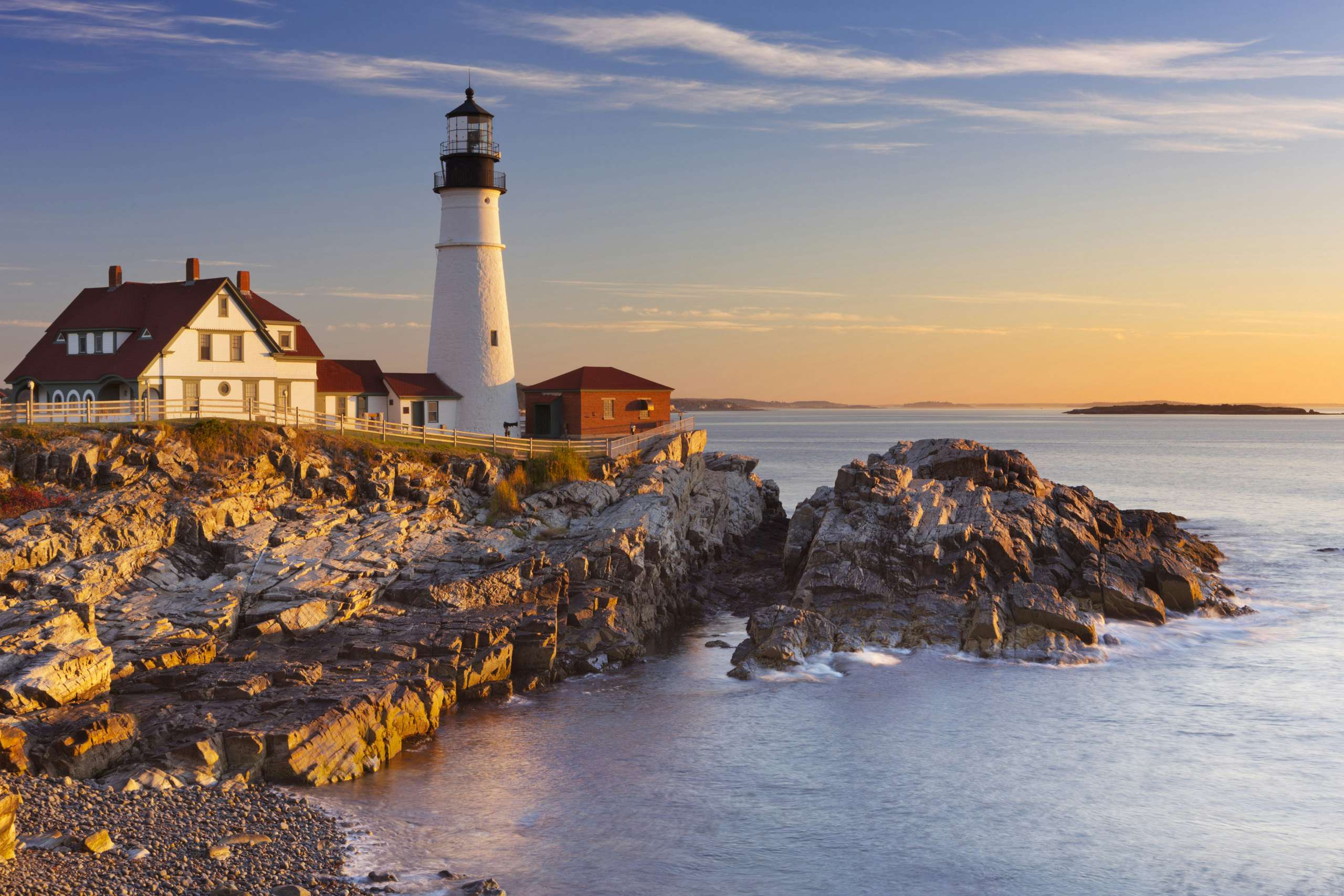 New England light house over the rocks and ocean