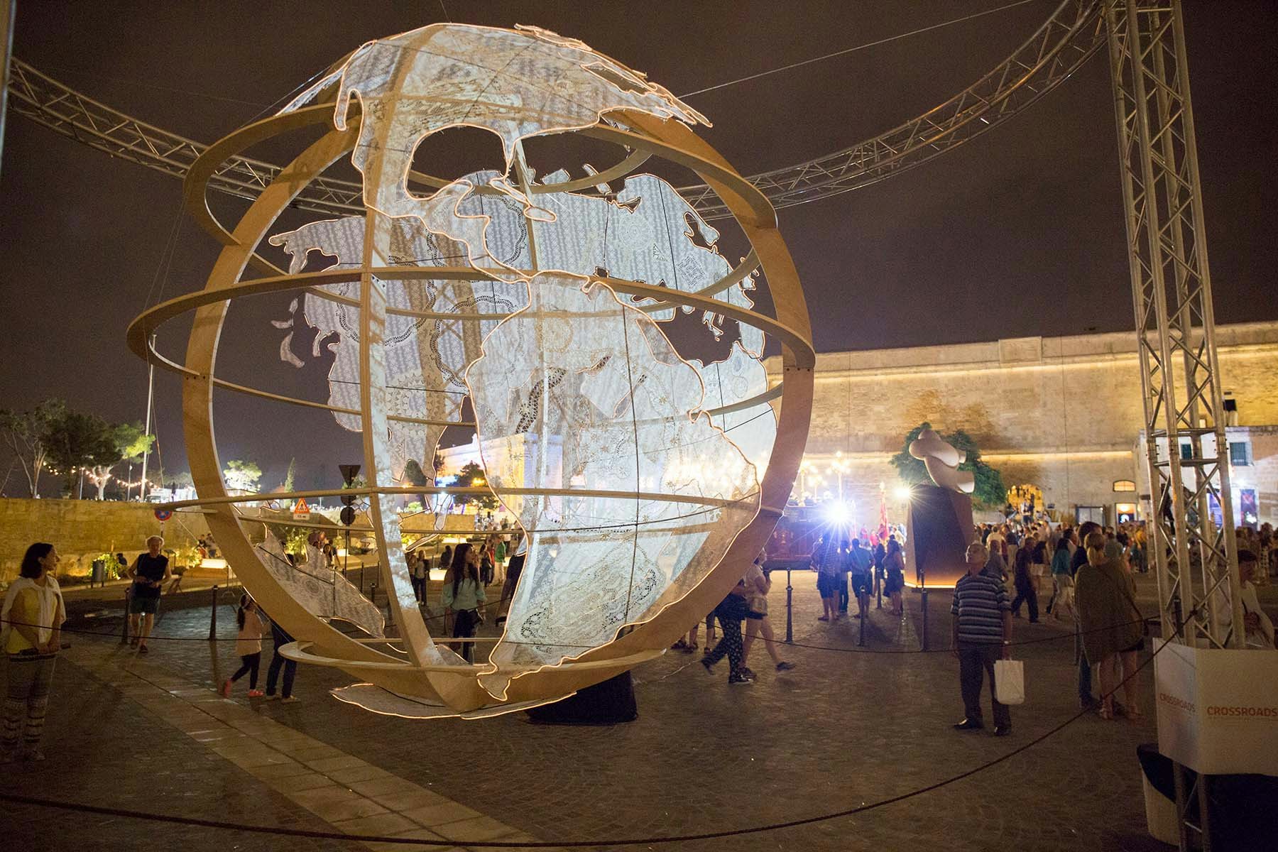 Notte Bianca in Malta, art sculpture of a globe illuminated with lights as someone admires it