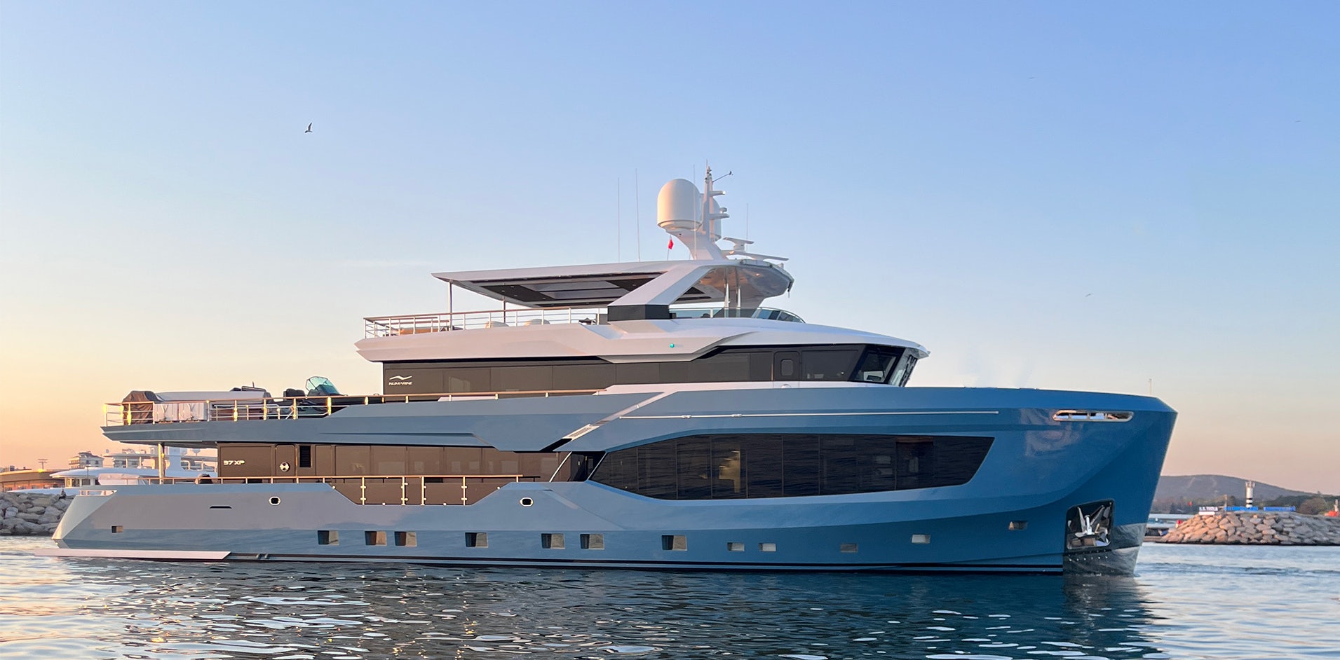 Numarine 37XP yacht rendering in the ocean with the sun setting behind.
