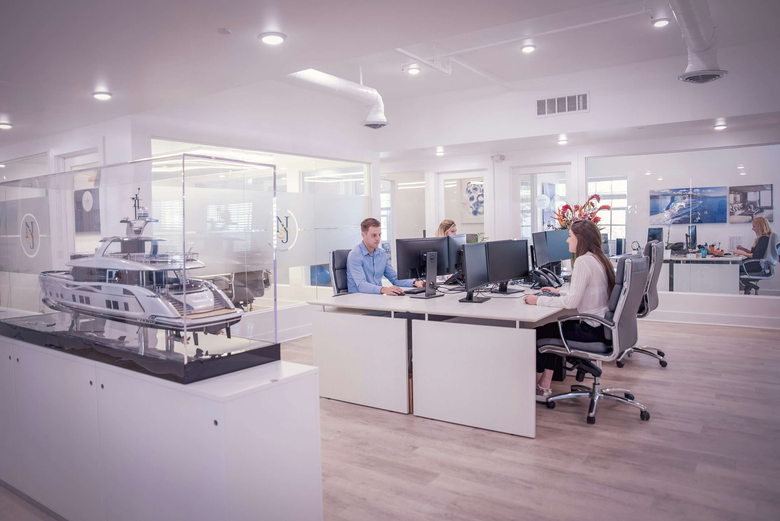 People working in open space desk at sleek, modern office