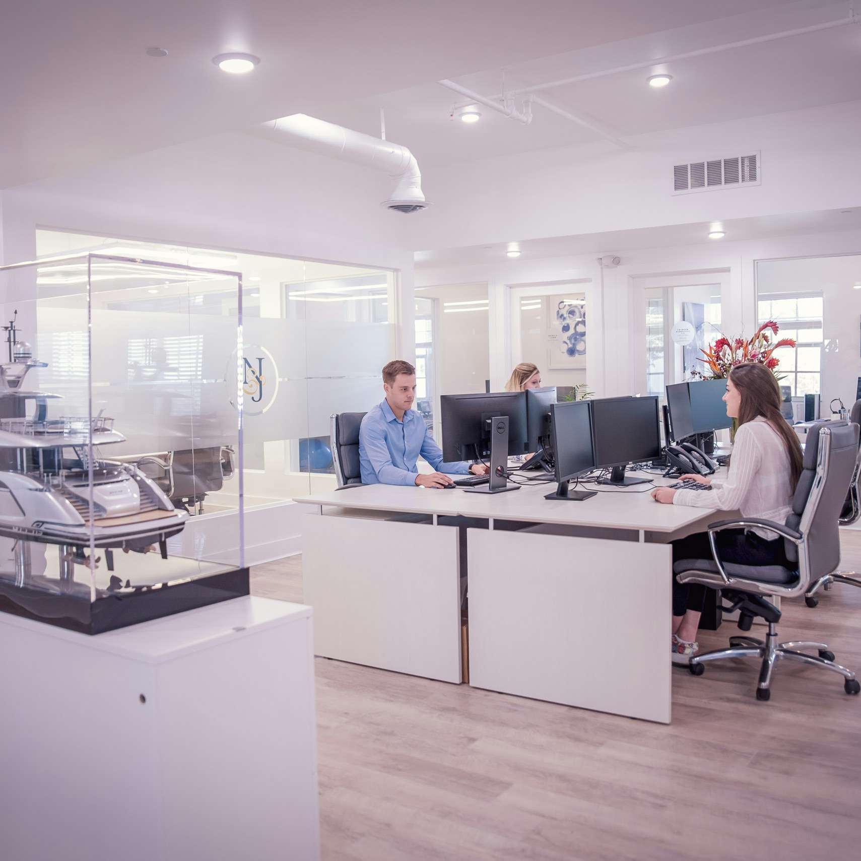 People working in open space desk at sleek | Modern Office for Yacht Charters | N&J