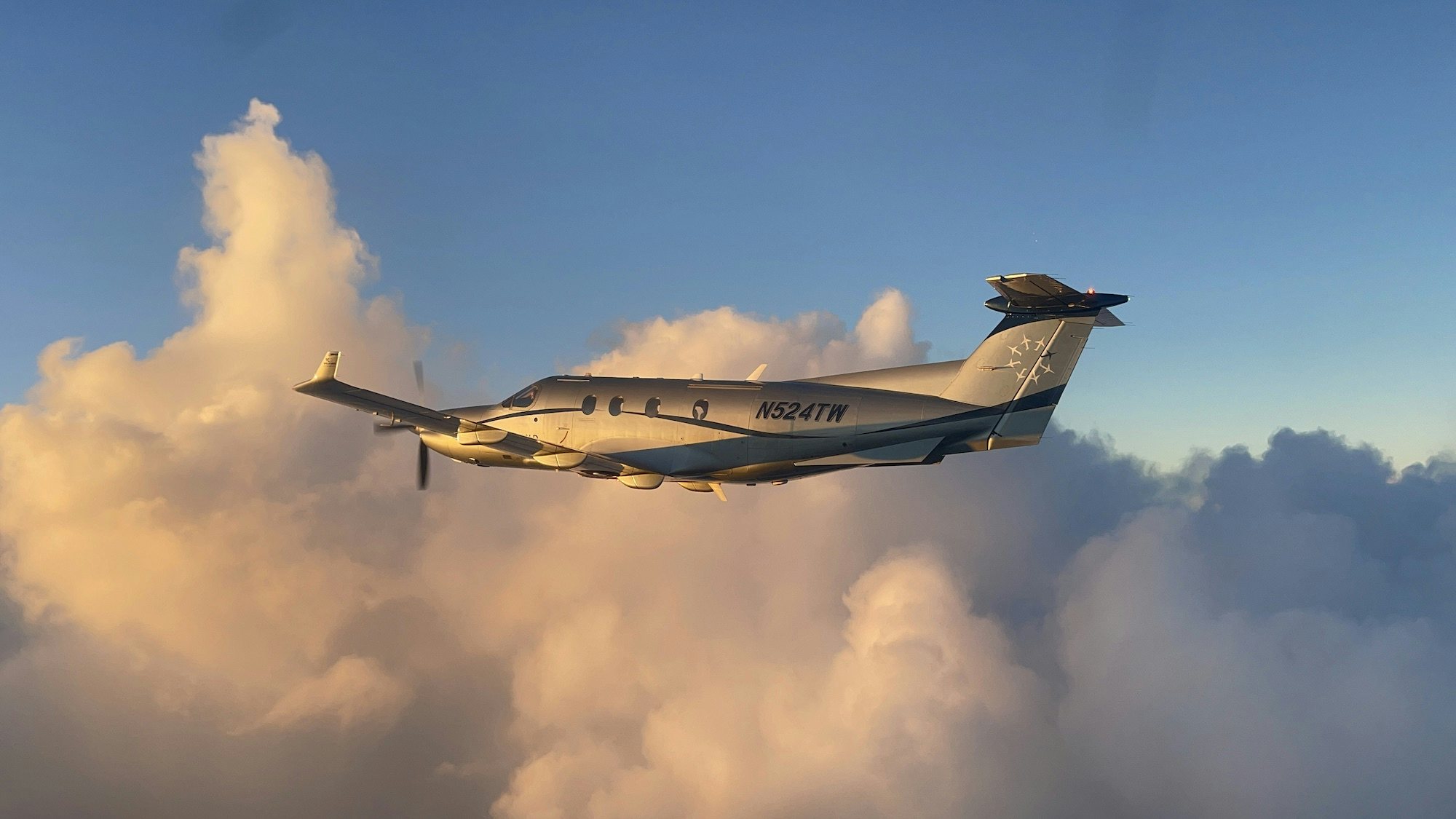 Pilatus in Flight BVI a plane in the air flying with clouds