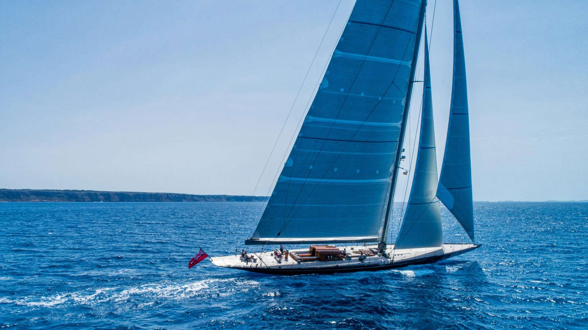 Side profile of RAINBOW sailing yacht on the water