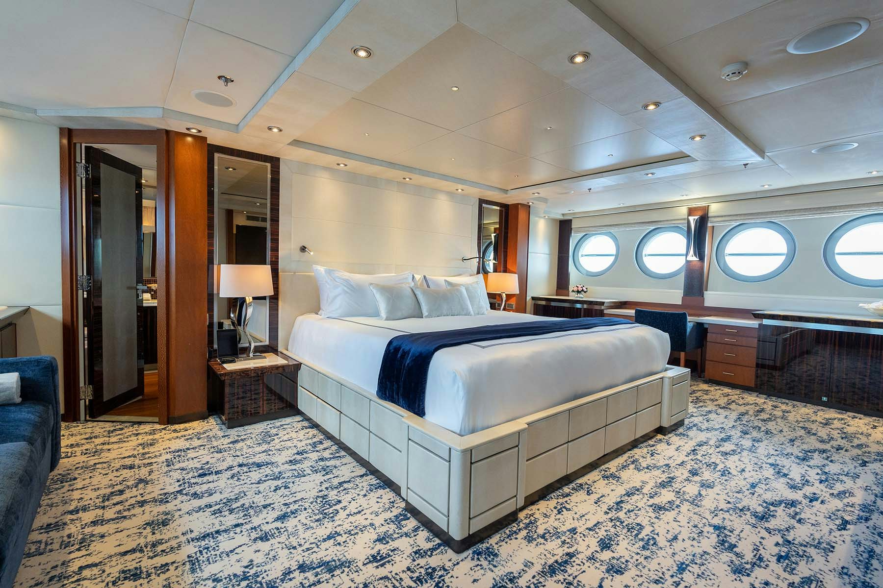 AQUANOVA master stateroom white and blue themed stateroom on superyacht