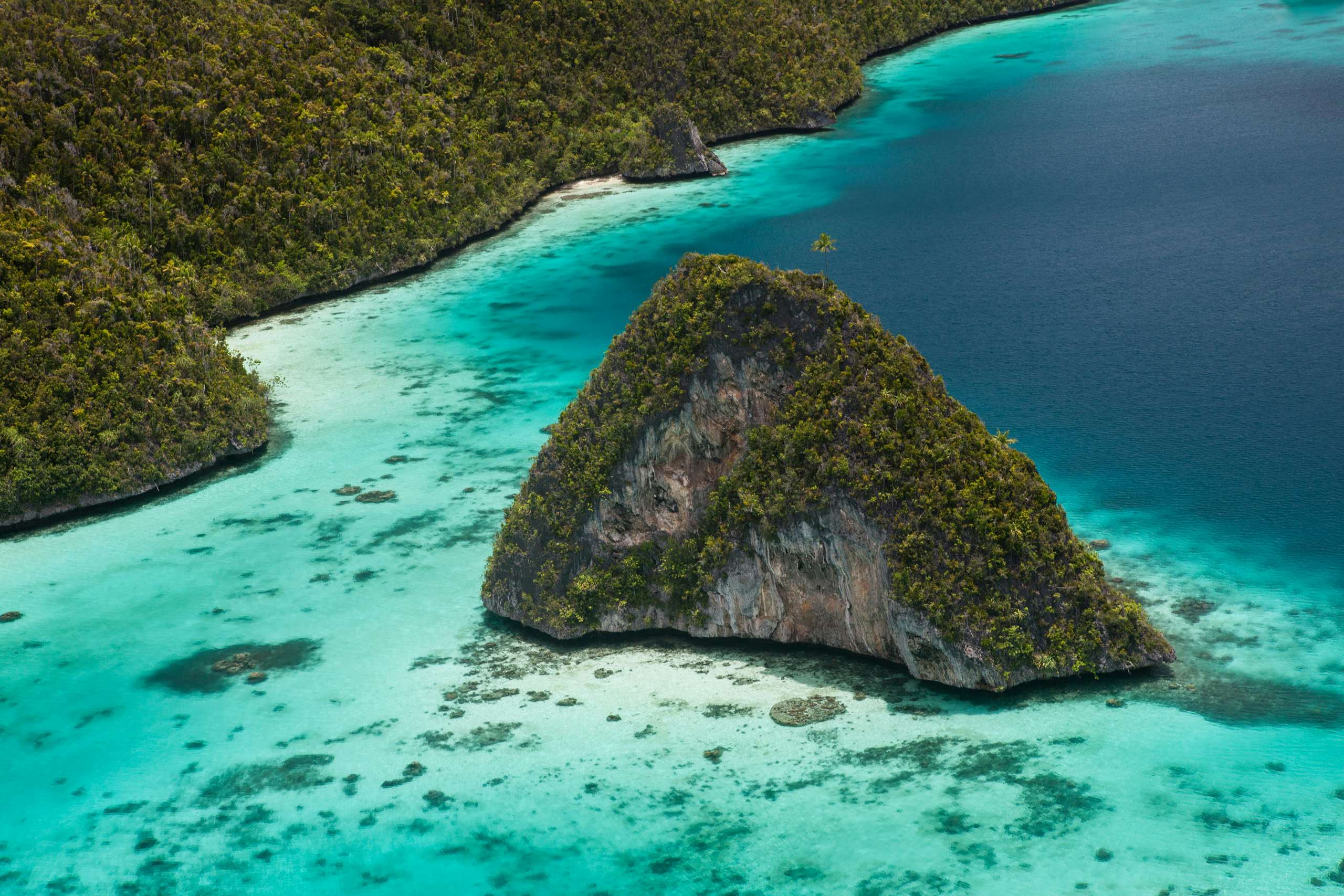 Indonesia Yacht Charter - Limestone islands rise from a gorgeous lagoon in Wayag, Raja Ampat, Indonesia. This remote, tropical region is known as the heart of the Coral Triangle due to its incredible marine biodiversity.