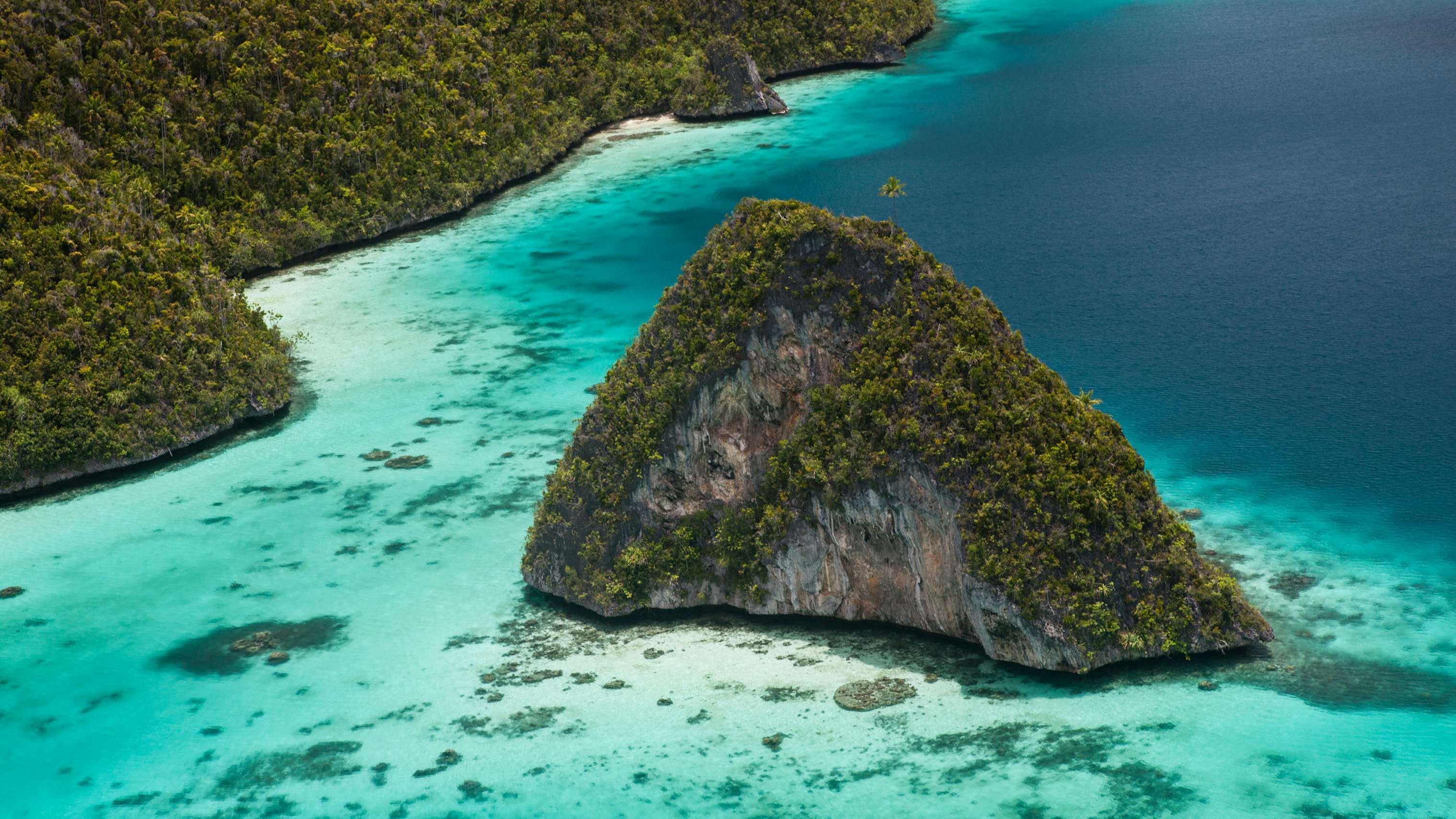 Indonesia Yacht Charter - Limestone islands rise from a gorgeous lagoon in Wayag, Raja Ampat, Indonesia. This remote, tropical region is known as the heart of the Coral Triangle due to its incredible marine biodiversity.