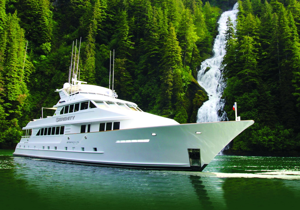 Charter Yacht Serenity in front of a waterfall in Alaska