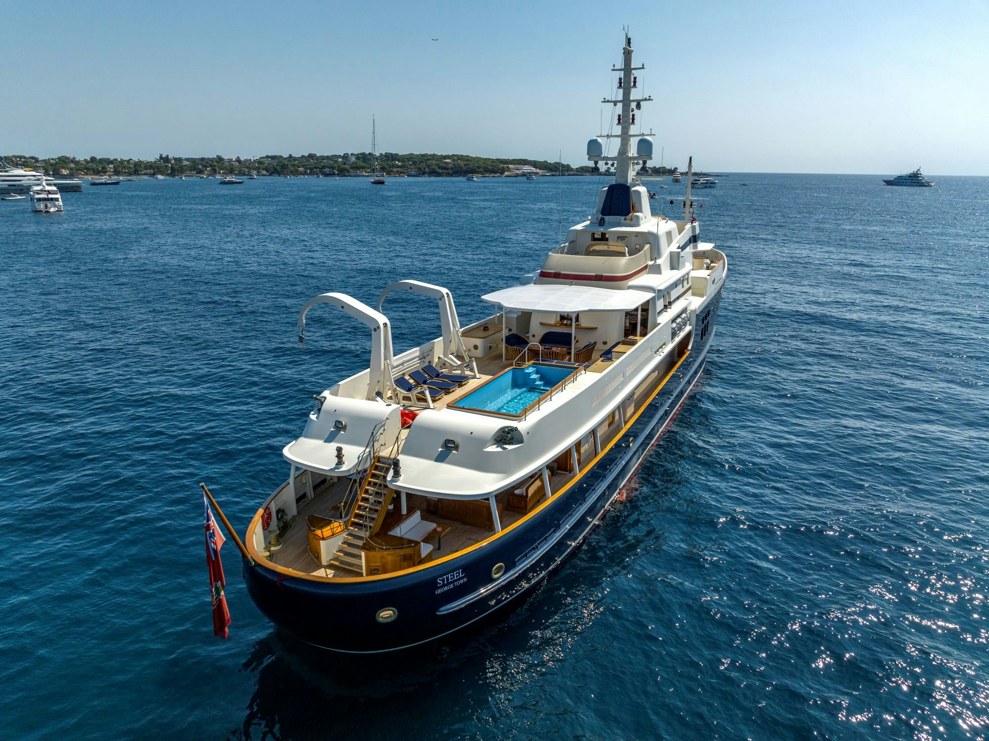 an aft view of yacht STEEL with her pool while anchored in the blue ocean