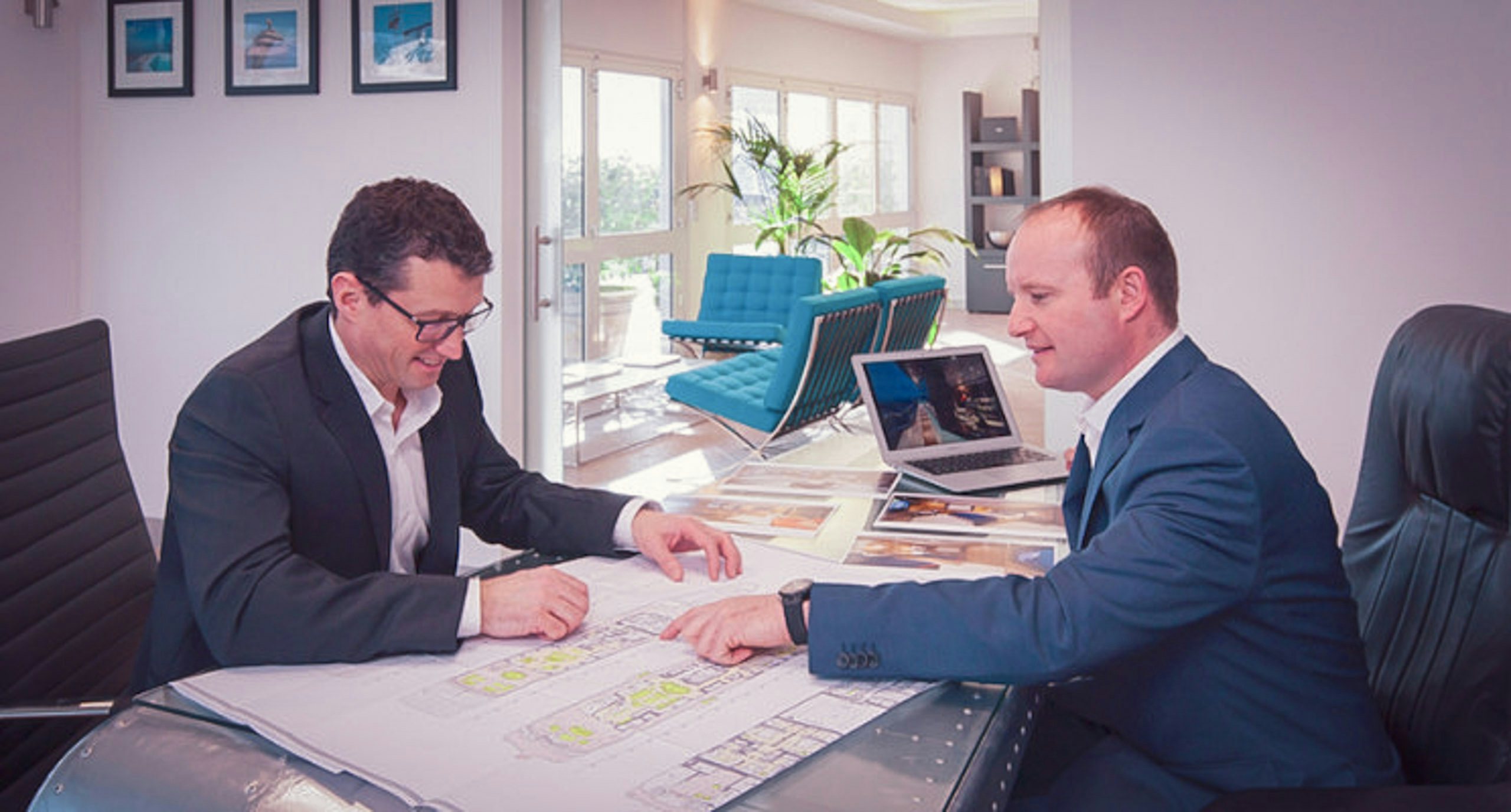 SYM_2 Yacht manager and client looking at yacht designs on desk