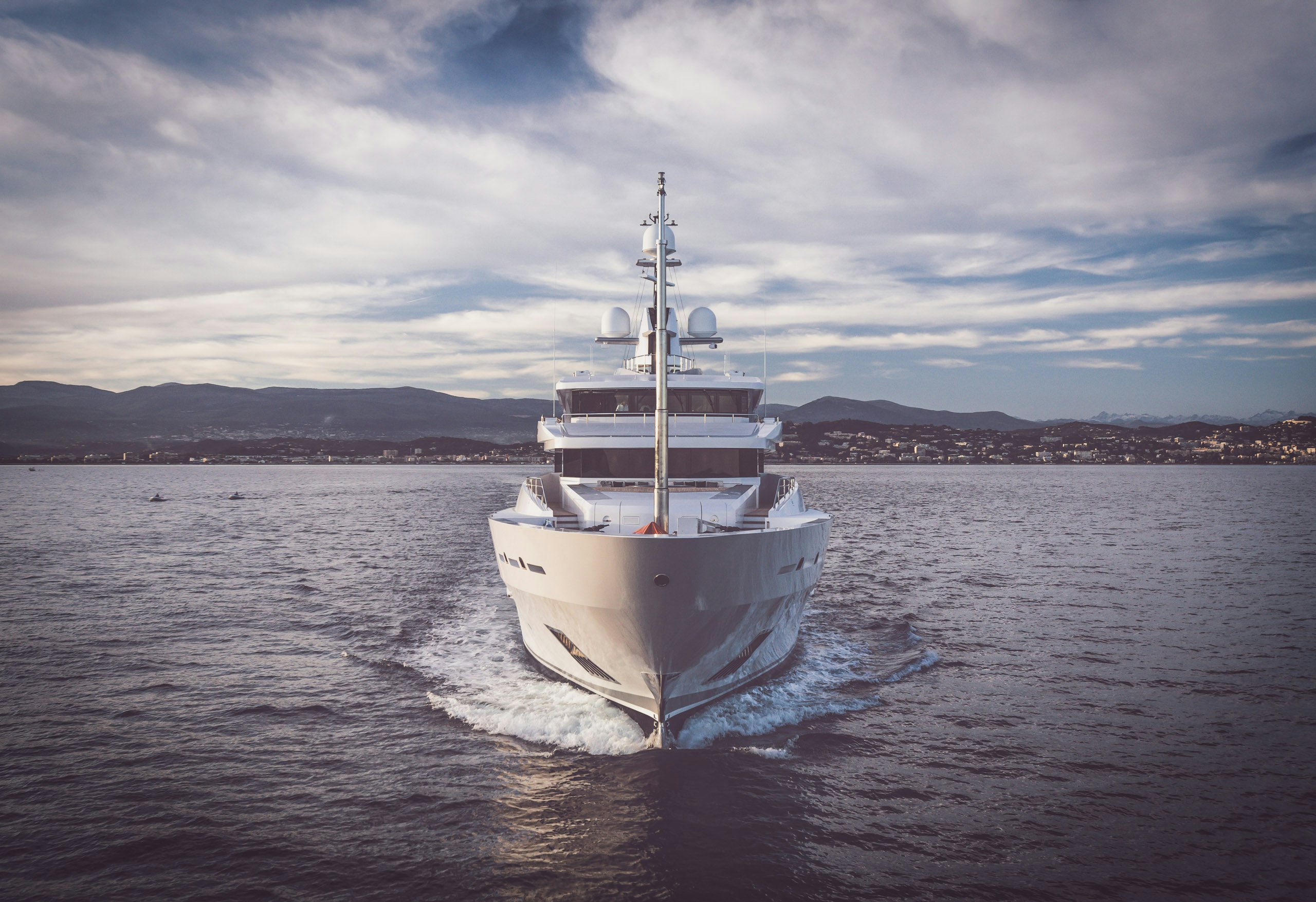 Front view of a superyacht cruising | Yachts for sale | Northrop & Johnson Superyacht cruising in the direction of the camera | Yacht for sale | N&J