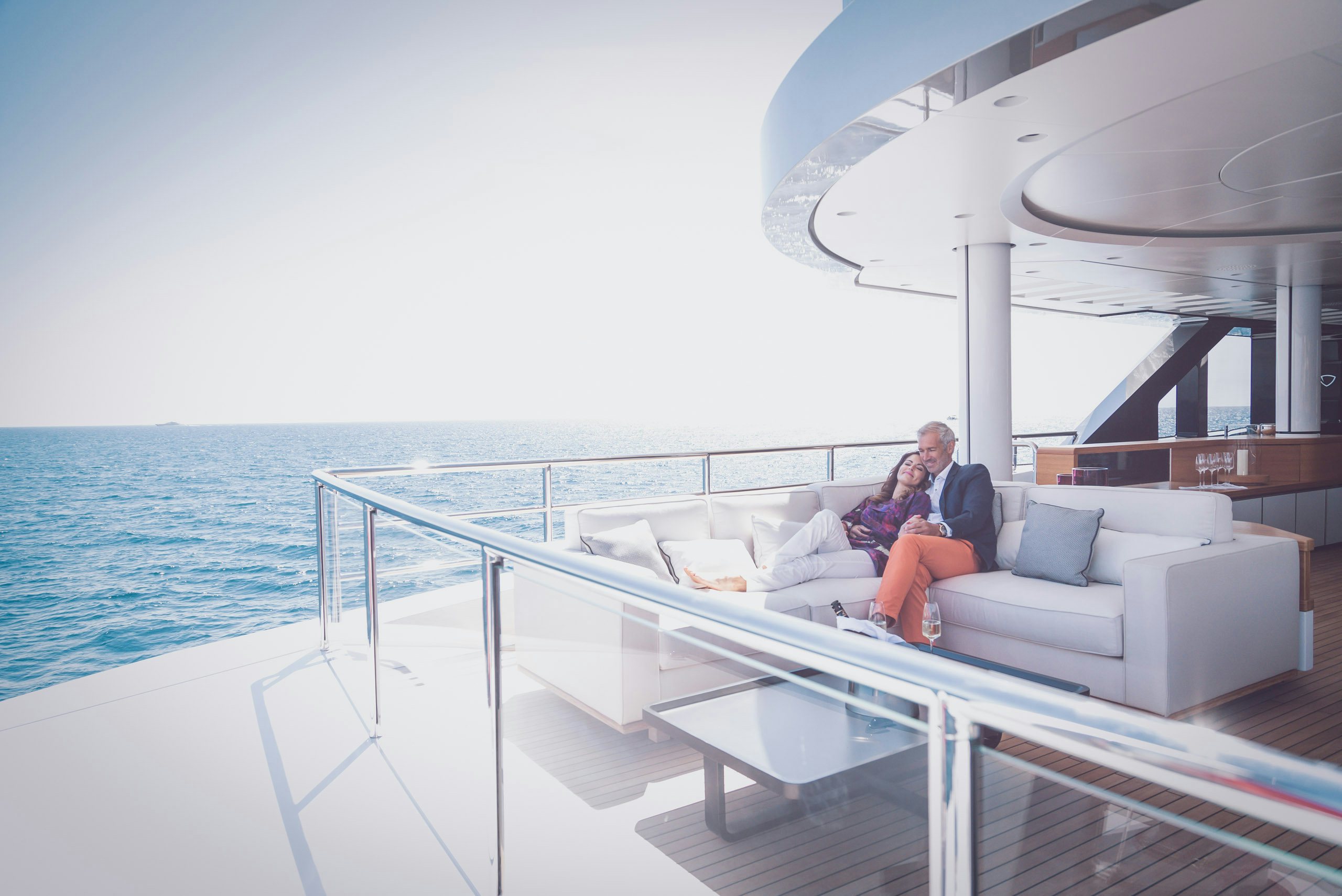 Sell your Yacht Couple Sitting on Luxury Yacht Deck
