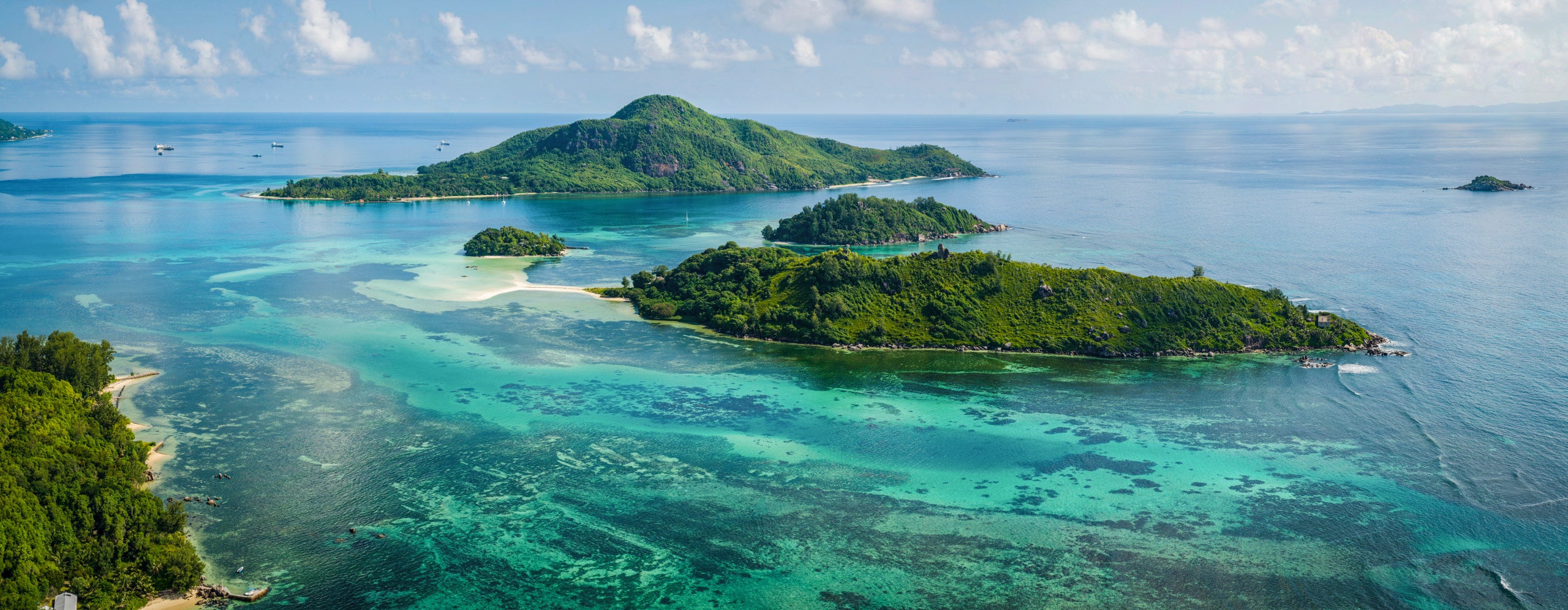 Seychelle Crewed Yacht Charter -Saint Anne Marine Park Seychelles Mahe, blue and green hued waters with small lush mountains Seychelle Crewed Yacht Charter -Saint Anne Marine Park Seychelles Mahe, blue and green hued waters with small lush mountains