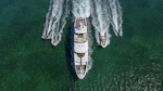 SilverLining yacht with her tenders cruising in greenish waters
