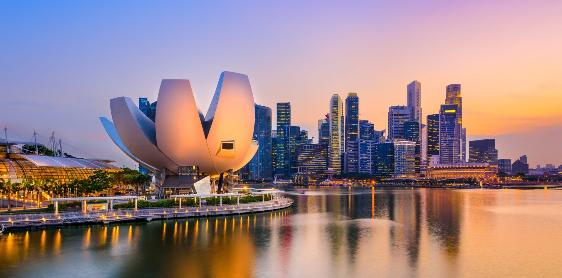 A panoramic view of Marina Bay during the Singapore Yachting Festival, showcasing luxurious yachts anchored in the serene waters with the city skyline in the background.