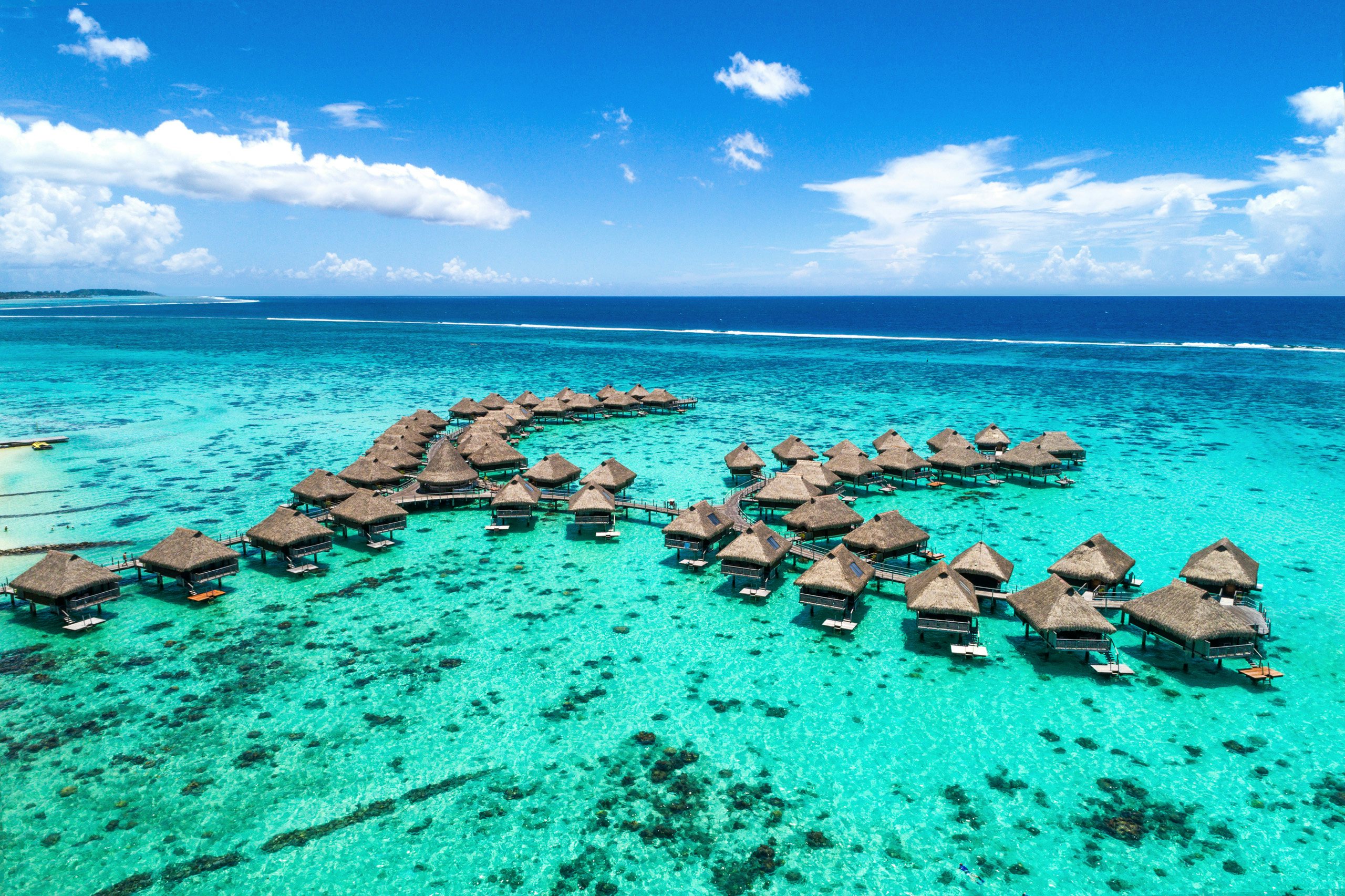 South Pacific Yacht Charter - South Pacific_Moorea South Pacific Yacht Charter - Huts in the beautiful waters of Moorea